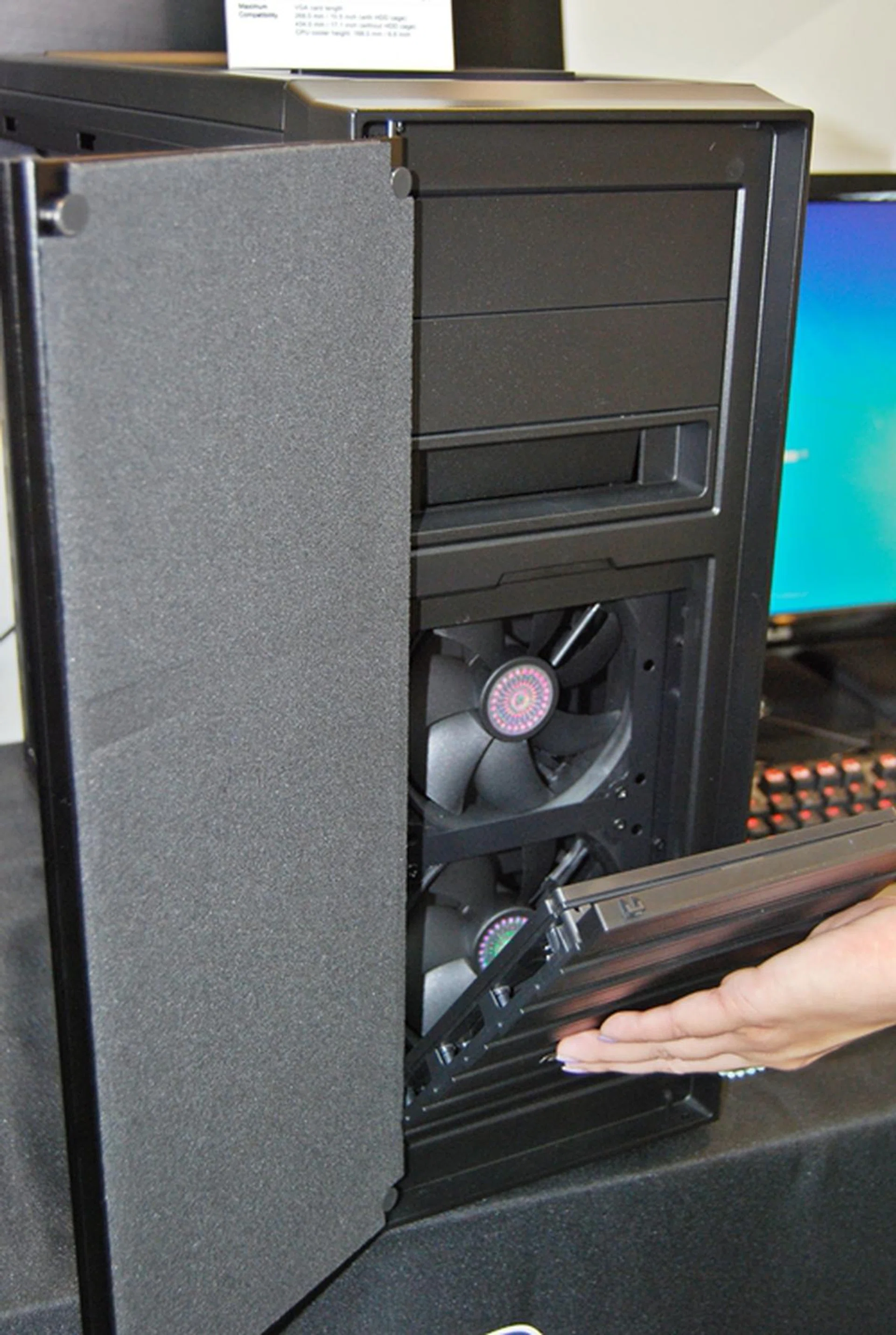 With the dust filter panel removed, we can see the pair of cooling fans. There is also sound dampening material on its front cover.