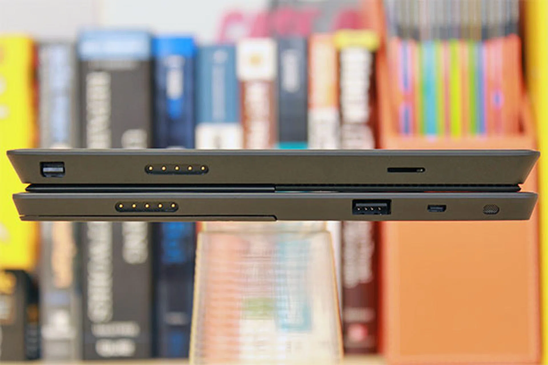 Port layout of the two devices is quite different on the right side. The Surface Pro has (from left) a mini-DisplayPort, power port, and a microSDXC card slot. The Surface RT's micro HDMI terminal is towards the far right in this picture; that means when it's standing, the port is nearer to the top.