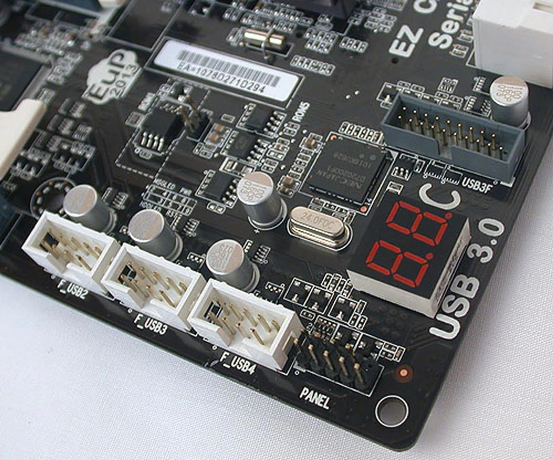 An LED segment that displays POST messages. It has a big Celsius sign painted at its side, which makes us wonder if it will display CPU or board temperatures after POST. You can also see the USB 3.0 front panel connector, which connects to a separate panel for the USB 3.0 functionality.
