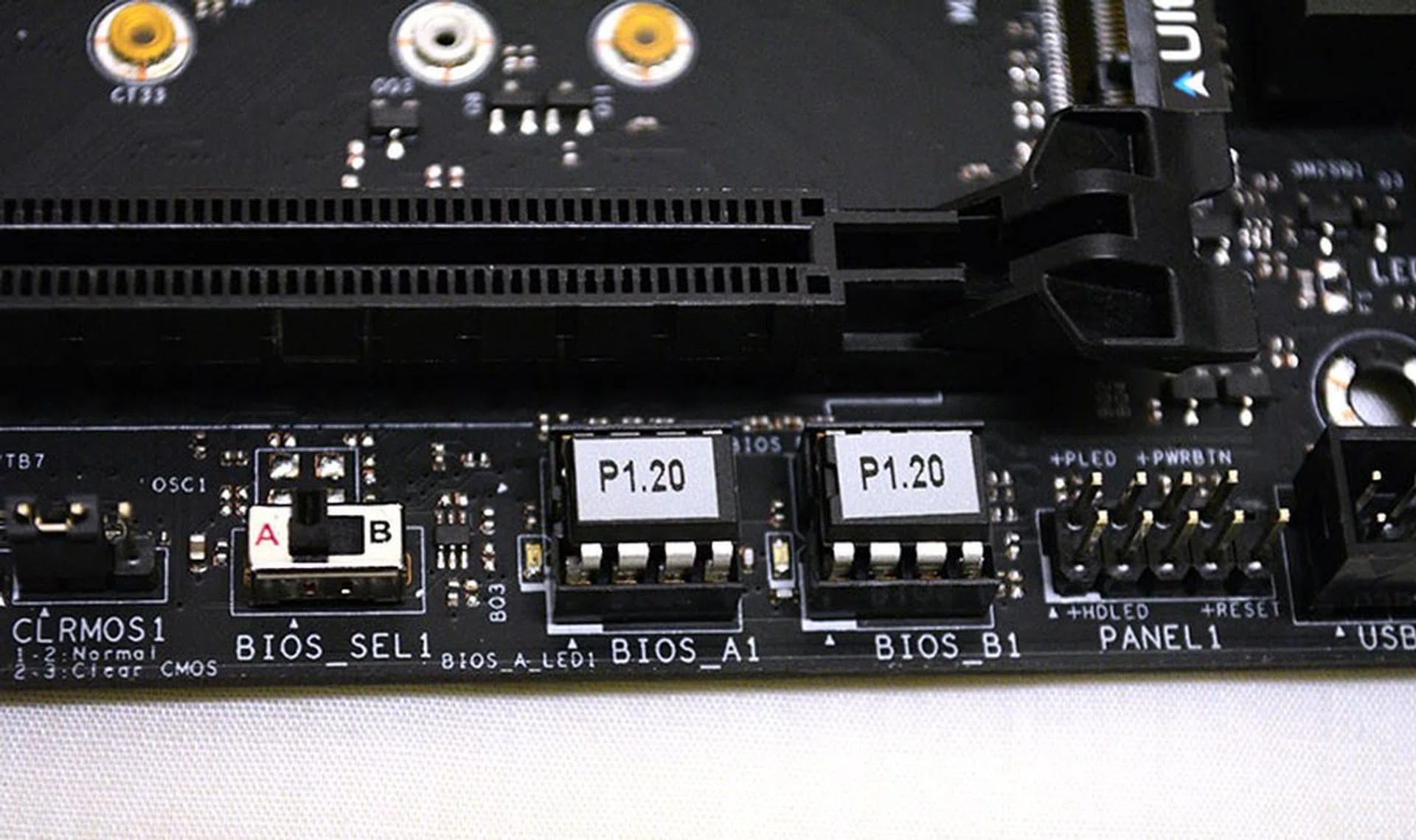 A clear CMOS jumper and dual BIOS switch are located along the board's bottom edge.