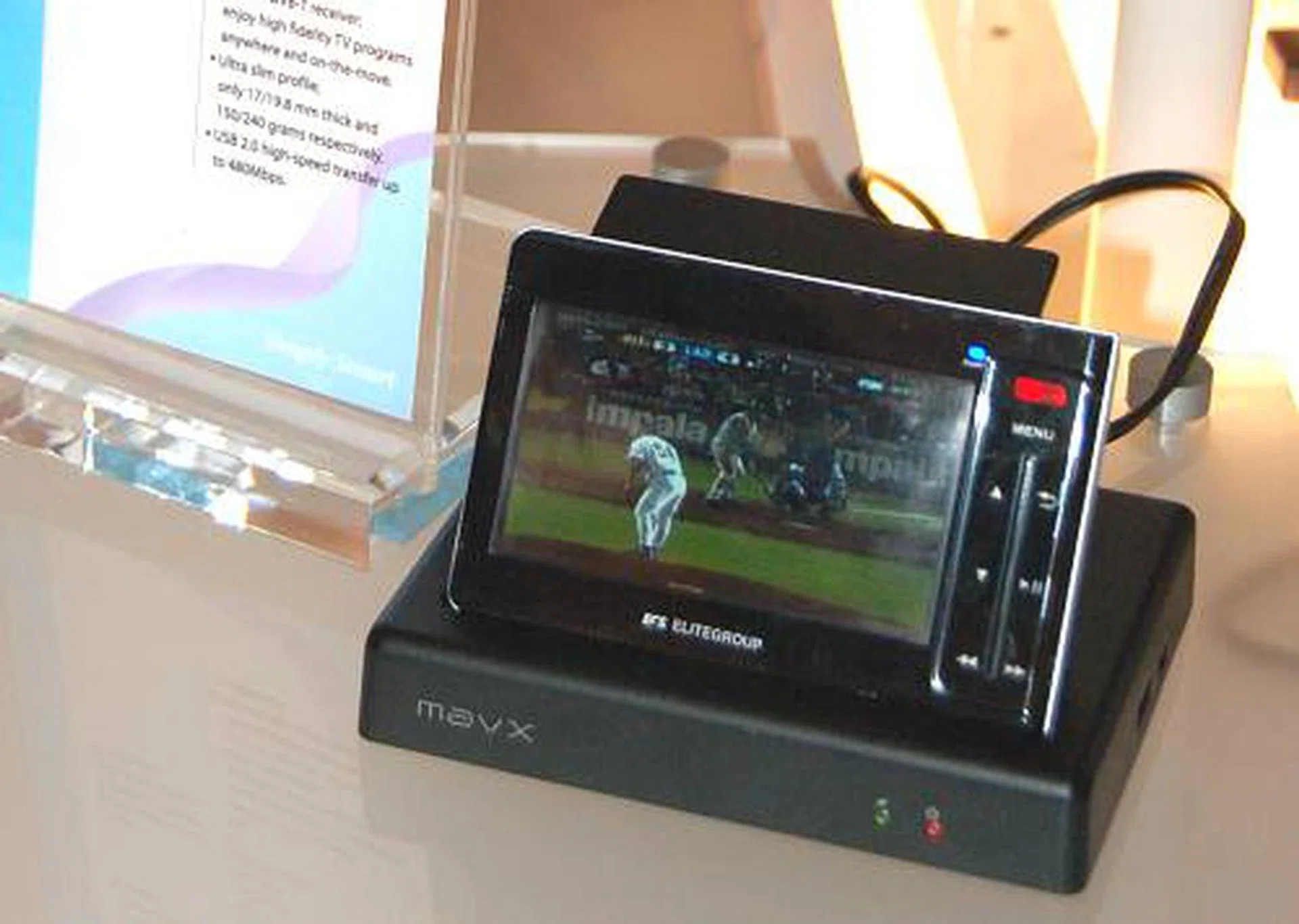 The EM-3535W is a pretty cool mobile player with a 4-inch WQVGA screen, 12GB HDD, SD card slot and has a built in DVB-T receiver. The cradle adds additional S-Video, composite, stereo out and acts as a battery charger. Runs on AMD Alchemy Au1200 media processor.