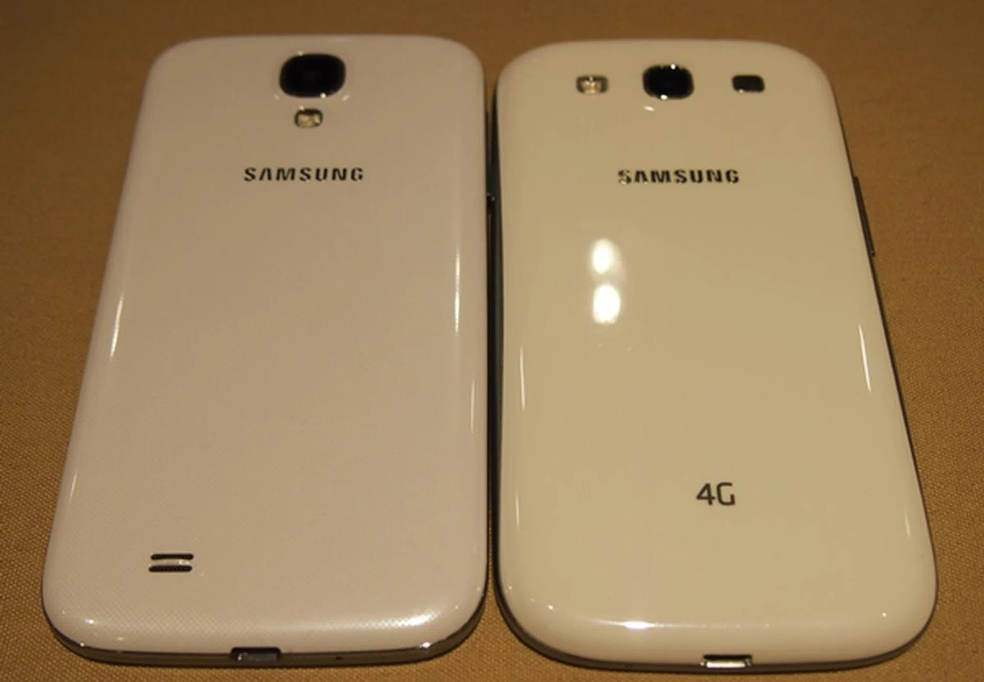The rear LED flash is now situated below the camera on the Samsung Galaxy S4 (left) and the speaker is shifted to the bottom left.
