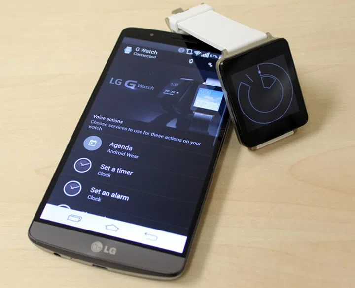 Seen here is the LG G Watch in white gold with the LG G3 smartphone.