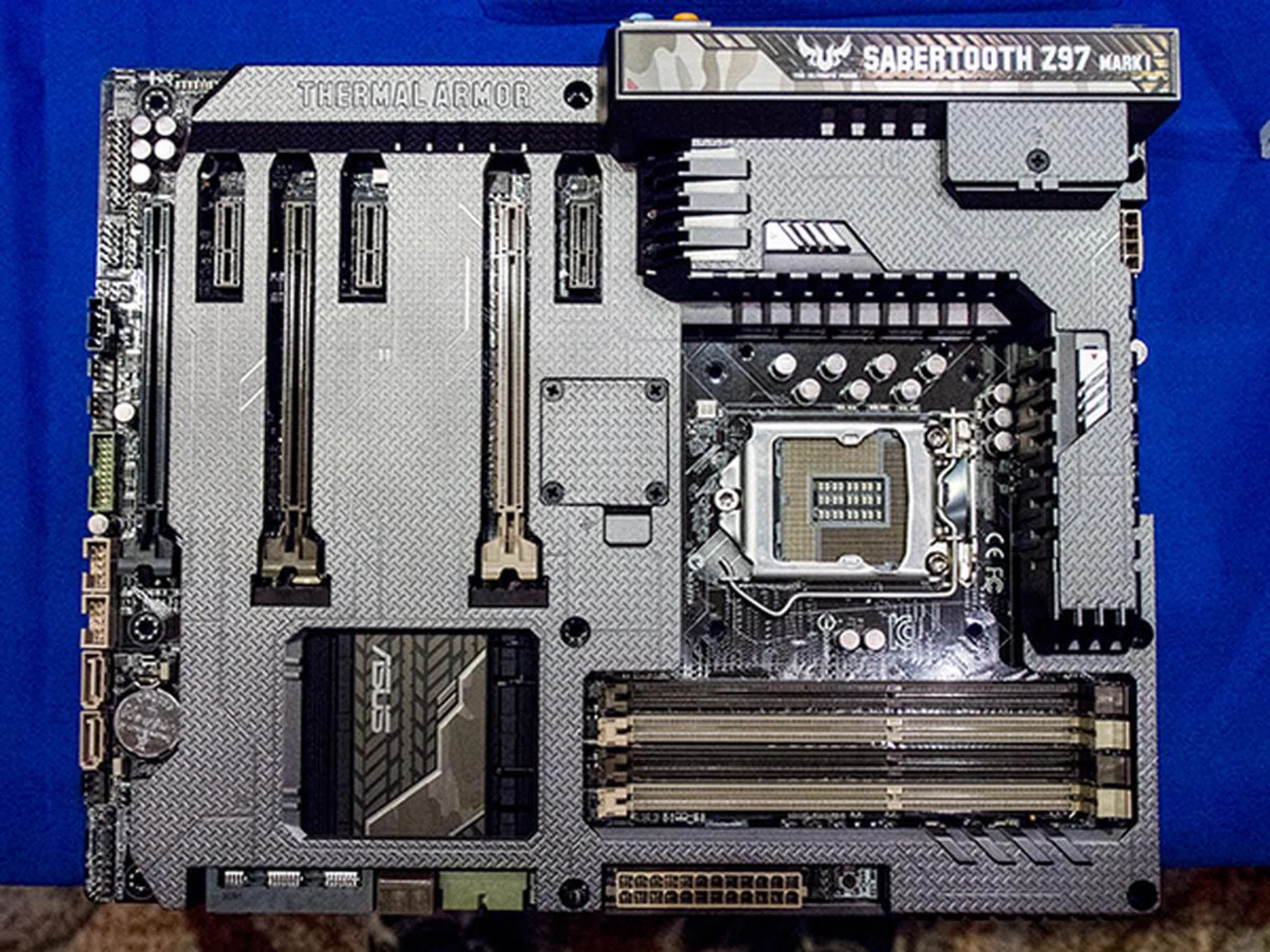 The ASUS Sabertooth Z97 Mark 1 with three PCIe graphics slot, 3x PCIe x1 slots, SATA Express, 8 SATA ports, 8 USB 3.0 ports and 8 USB 2.0 ports. The TUF series do not have support for the new M.2 storage interface.