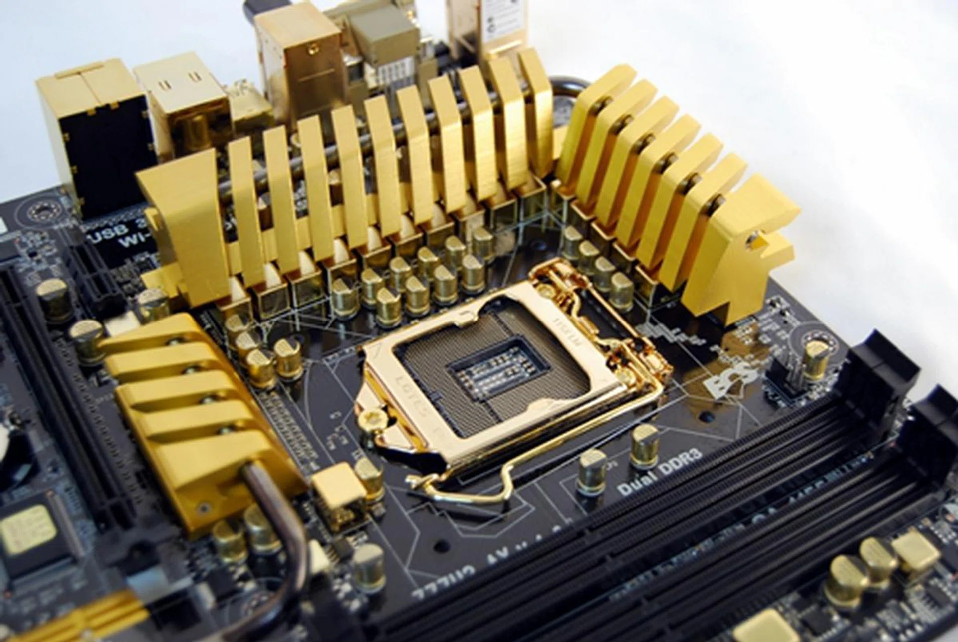 The LGA 1155 CPU socket's vicinity is the portion of the board where you hit gold, literally. The MOSFET IC's gilded heatsinks, chokes and capacitors which are all treated with a layer of gold. Even the CPU socket latch is not spared such lavish treatment.