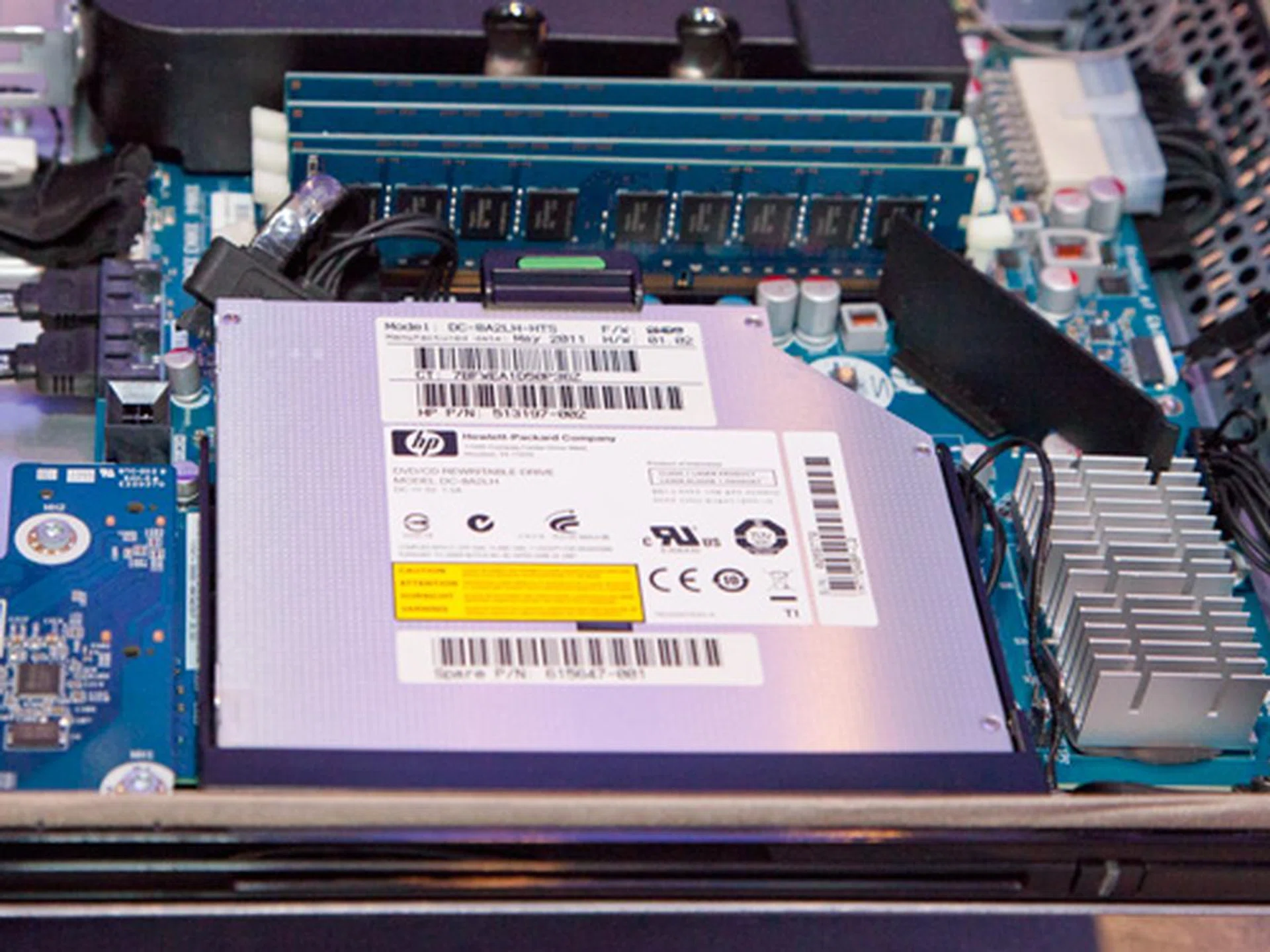 On the right side of the motherboard, you'll find the slot loading optical drive which can also be swapped and replaced easily. Located beside the optical drive, you'll find four regular DIMM slots, similar to those used in desktops. Adding more memory to the system would be extremely economical since it uses regular desktop memory modules. You can further reduce cost by using non-ECC memory.
