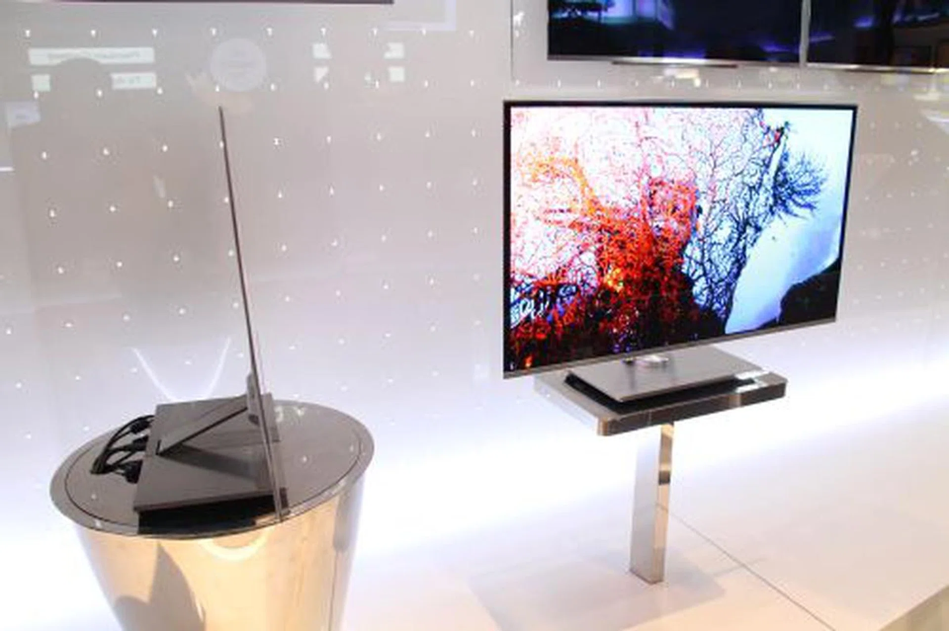 LG Electronics has on display the world's slimmest Full HD 3D OLED TV with a 31" screen size. While the unit is a prototype, it has a thickness of only 0.29cm and has virtually no cross talk issues currently plaguing 3D-TVs using LED LCD or plasma technology, due to its use of fluorescent technology, not backlighting. The OLED TV impressed many journalists with its stunning color quality and design, and many expect it to cost an arm and a leg when plans are made to release it sometime next year.