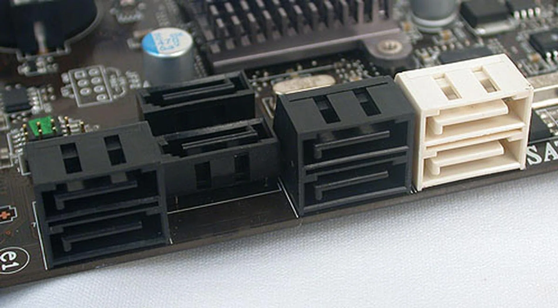 The six black SATA ports are 3Gbps only, offered by the SB710 chip. The two in white however are SATA 6Gbps capable and are powered by a Marvell 9128 chip. Don't ask us why two of the black SATA ports are facing upwards instead of being in line with the rest. We have no idea why MSI went with such a strange design, but at least it doesn't appear to interfere with your graphics cards.