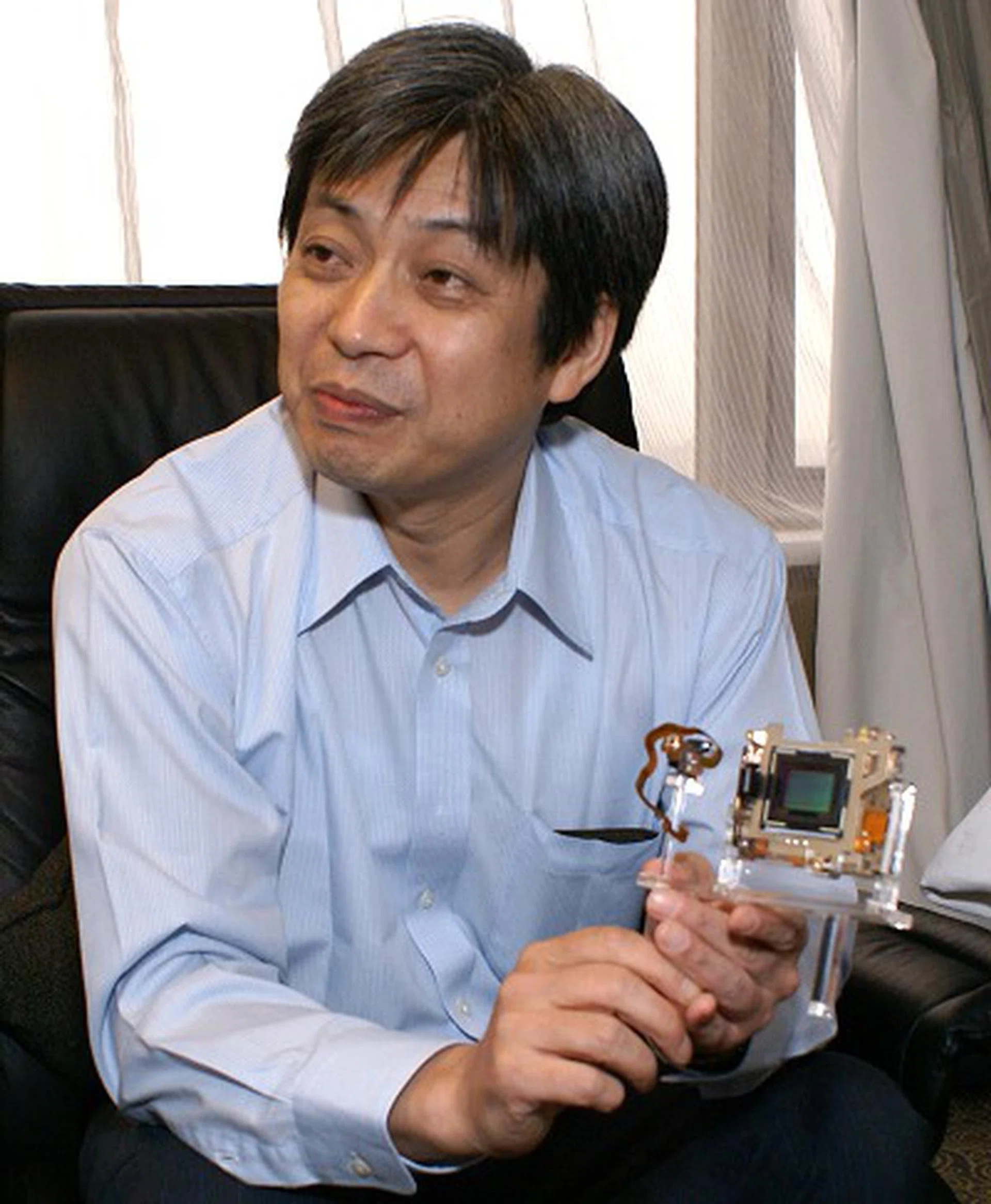 In his hands, Mr. Keiichi Ishizuka holds the Alpha A700's CMOS sensor module.