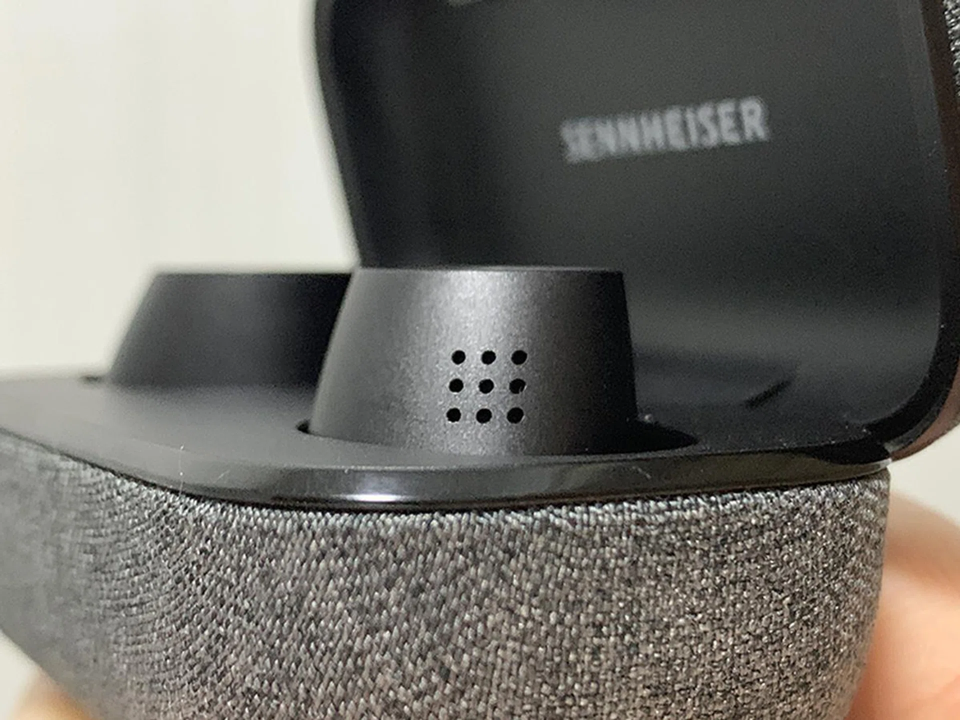 The mics that pick up ambient noise for processing lie within these holes, on each earbud.