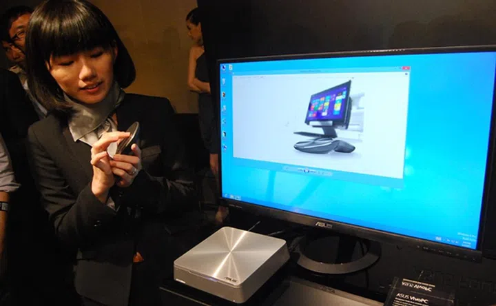 An ASUS spokesperson who demonstrated the use of the circular trackpad of the VivoMouse. The trackpad-optical mouse was paired with a VivoPC that is a new Windows 8 compact entertainment PC.