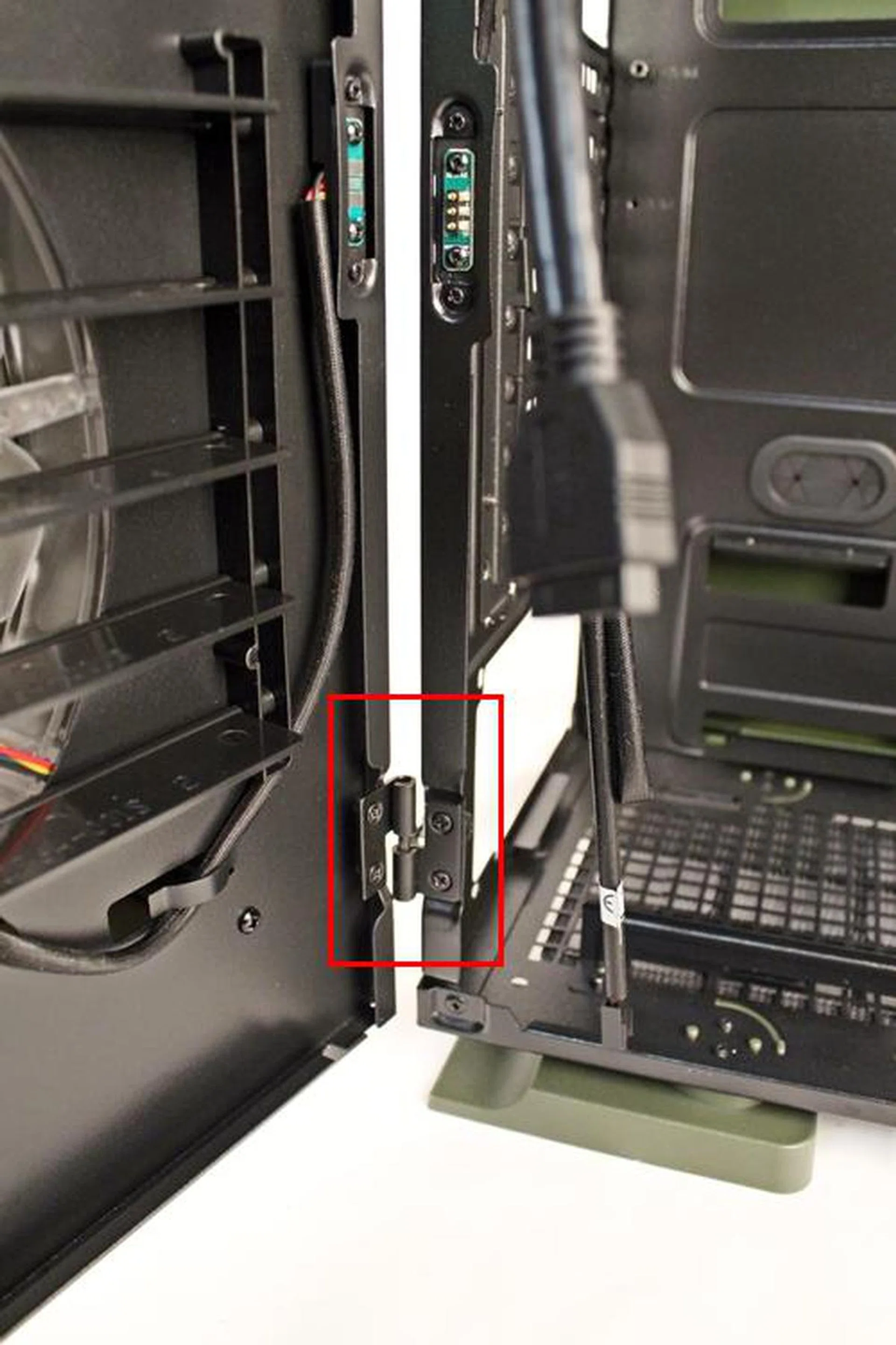 This is the bottom hinge of the side panel door; there is another near the top. Lifting the side panel door off its two hinges is an easy feat.