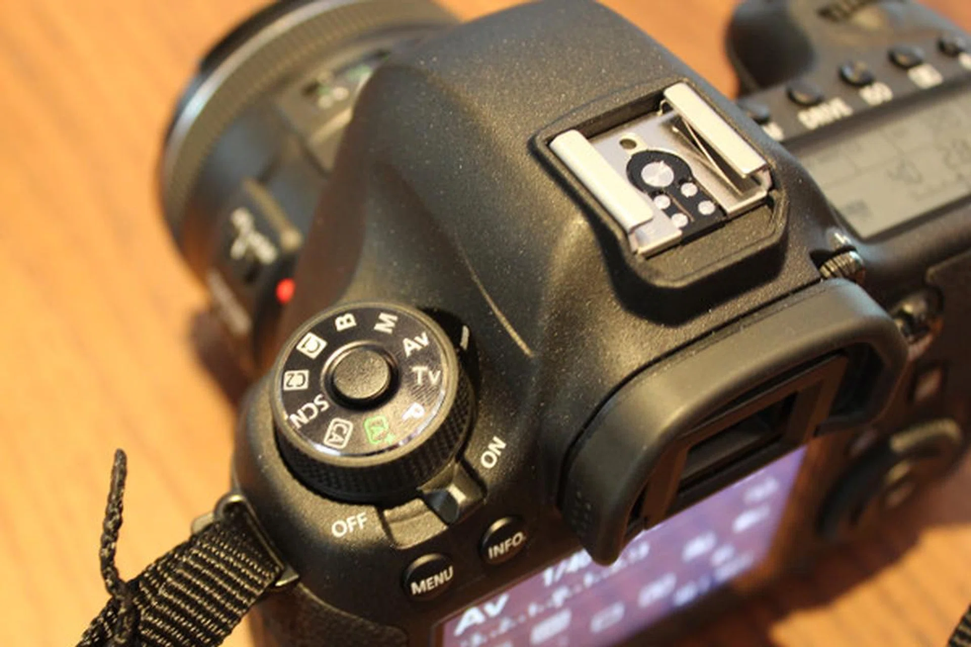 The Power switch is located behind the mode dial, unlike previous full-frame EOS models. 