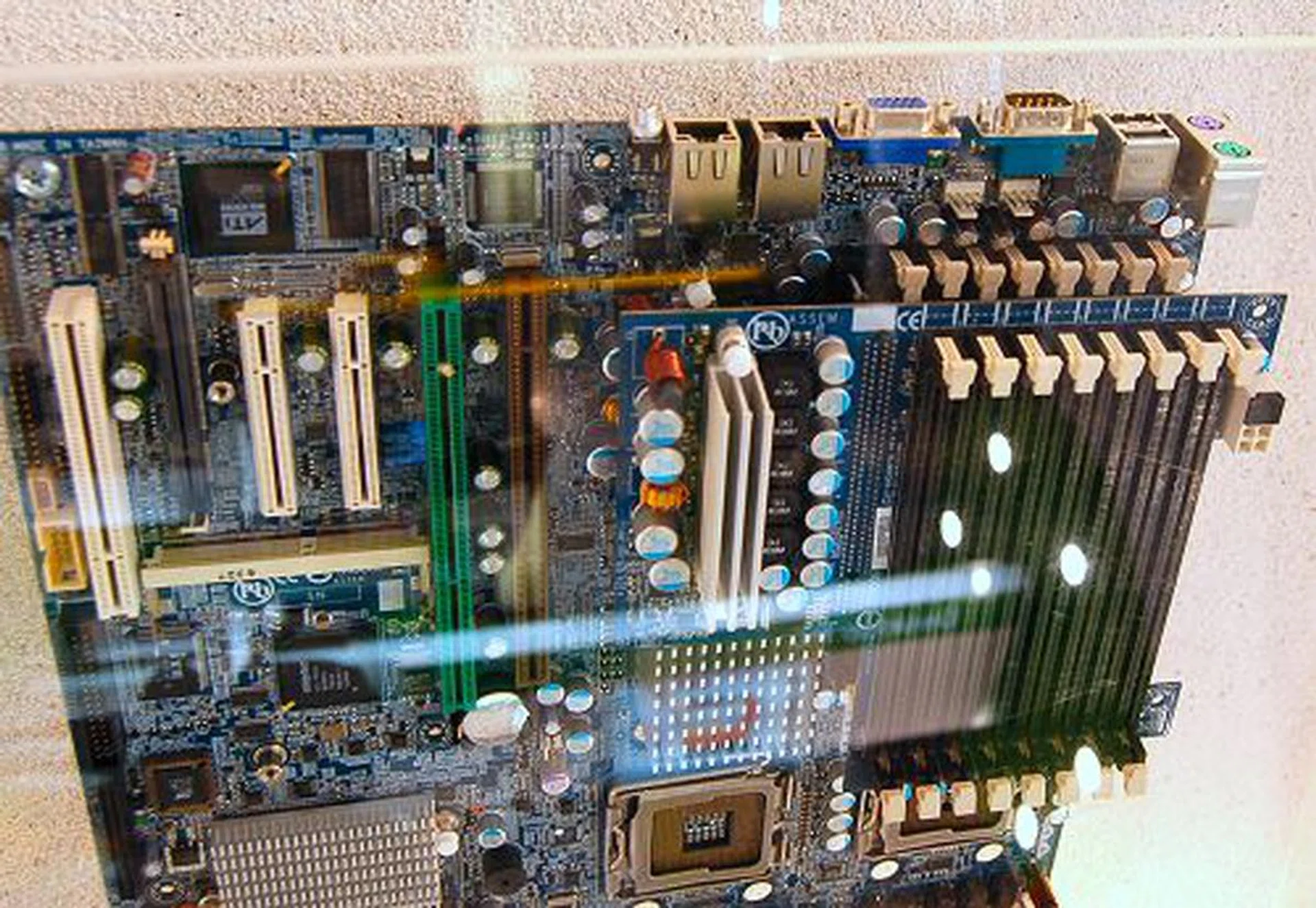  If 32GB of memory isn't adequate, this GA-7BESP-RH should do the job nicely with its 16 DIMM slots capable of addressing 64GB of memory. The board itself is quite similar to the GA-7BESH-RH with the exception that this is optimized for 2U rack systems and it uses a riser card of sorts to achieve it massive memory support (as shown in this shot).  