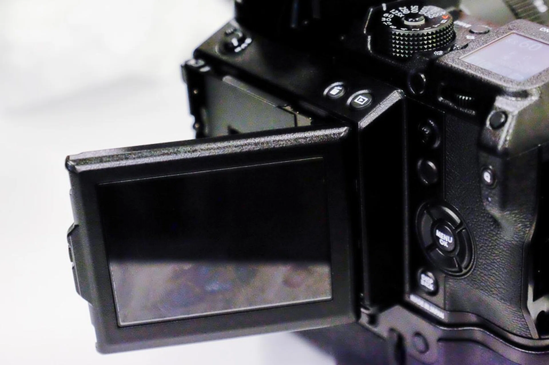 The EVF tilts to the side and up and down so you can use it even in portrait position.