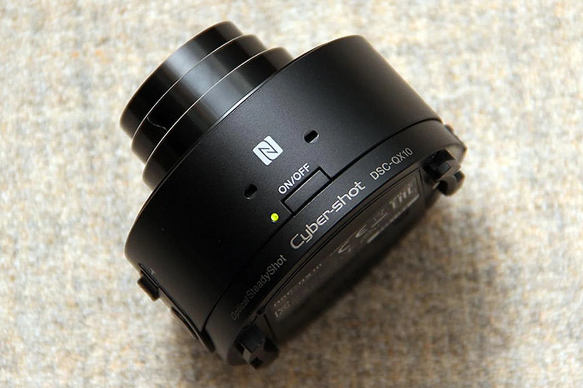 There's an N logo on the top of the QX10; this marks the spot where your NFC-enabled smartphone should touch. There's also the power button, status indicator, and microphone.