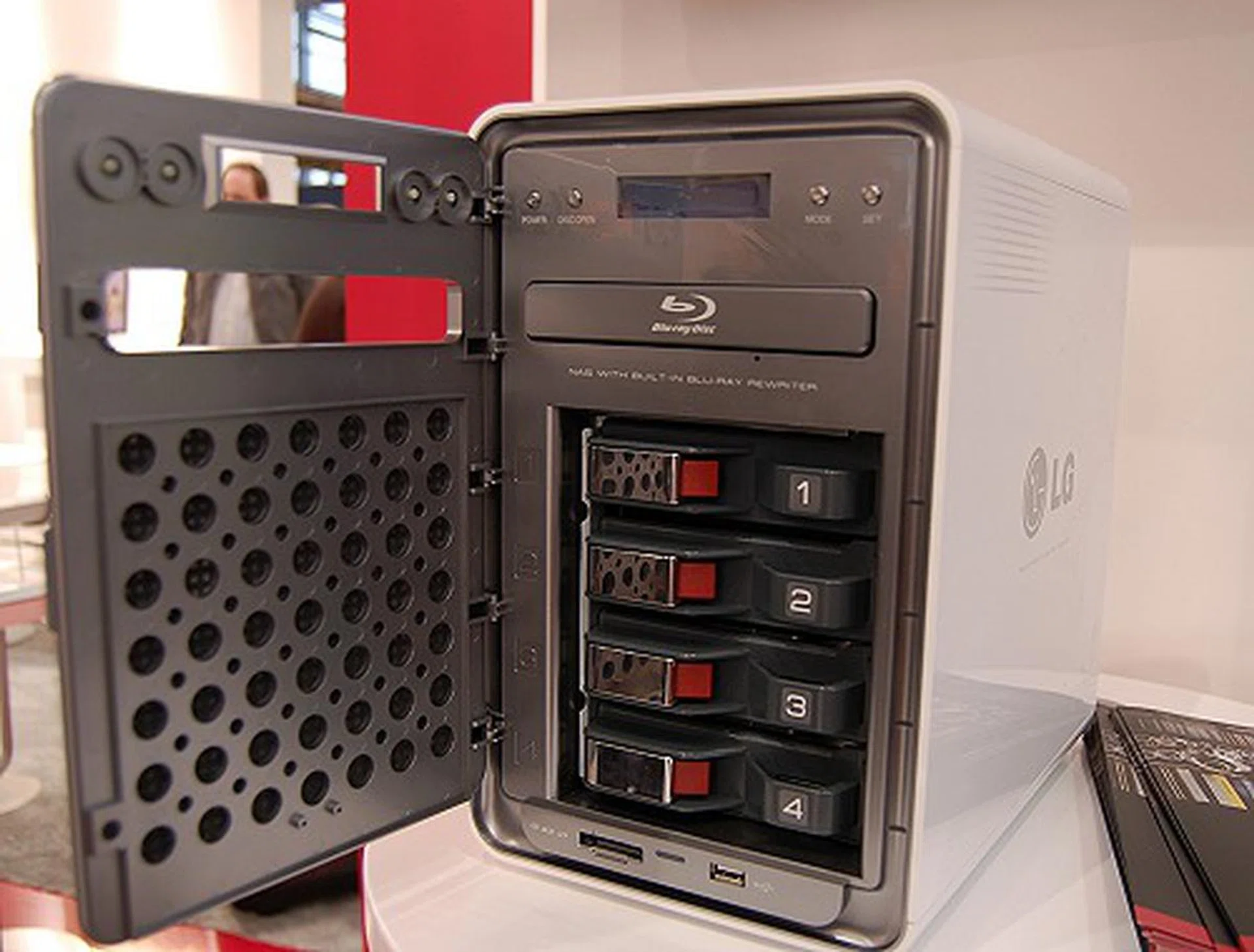  It is a four-bay NAS box with RAID level 0, 1, 5, 10 and JBOD. Supports drive hot-swapping and has a small LCD screen for status indication and controls via four buttons. It even has a Blu-ray writer for massive archival of up to 50GB on each dual-layer Blu-ray disc.  