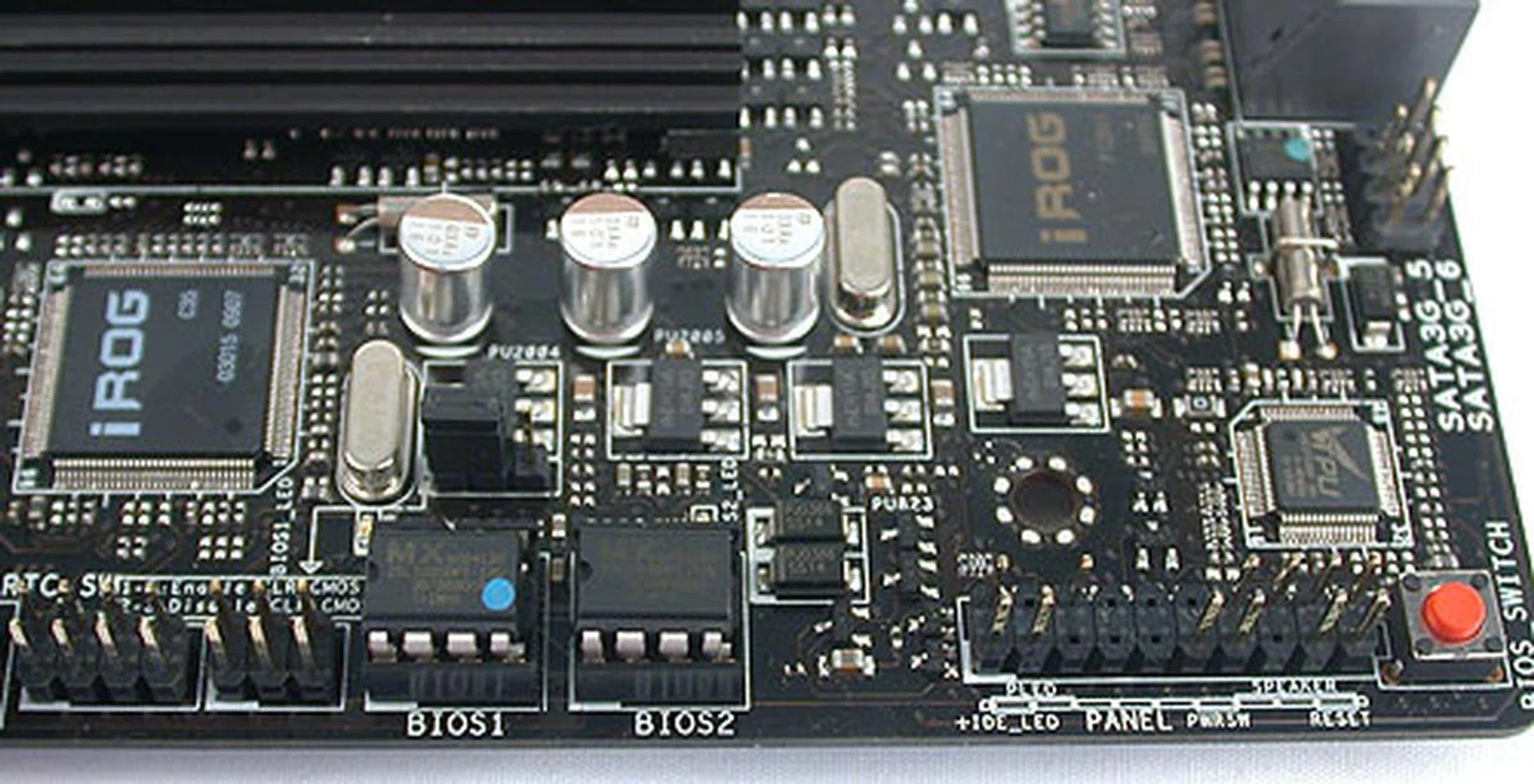The front panel connectors are here along with the dual BIOS chips. A BIOS switch (the red button) allows users to toggle between two different BIOS and their settings at a touch. 