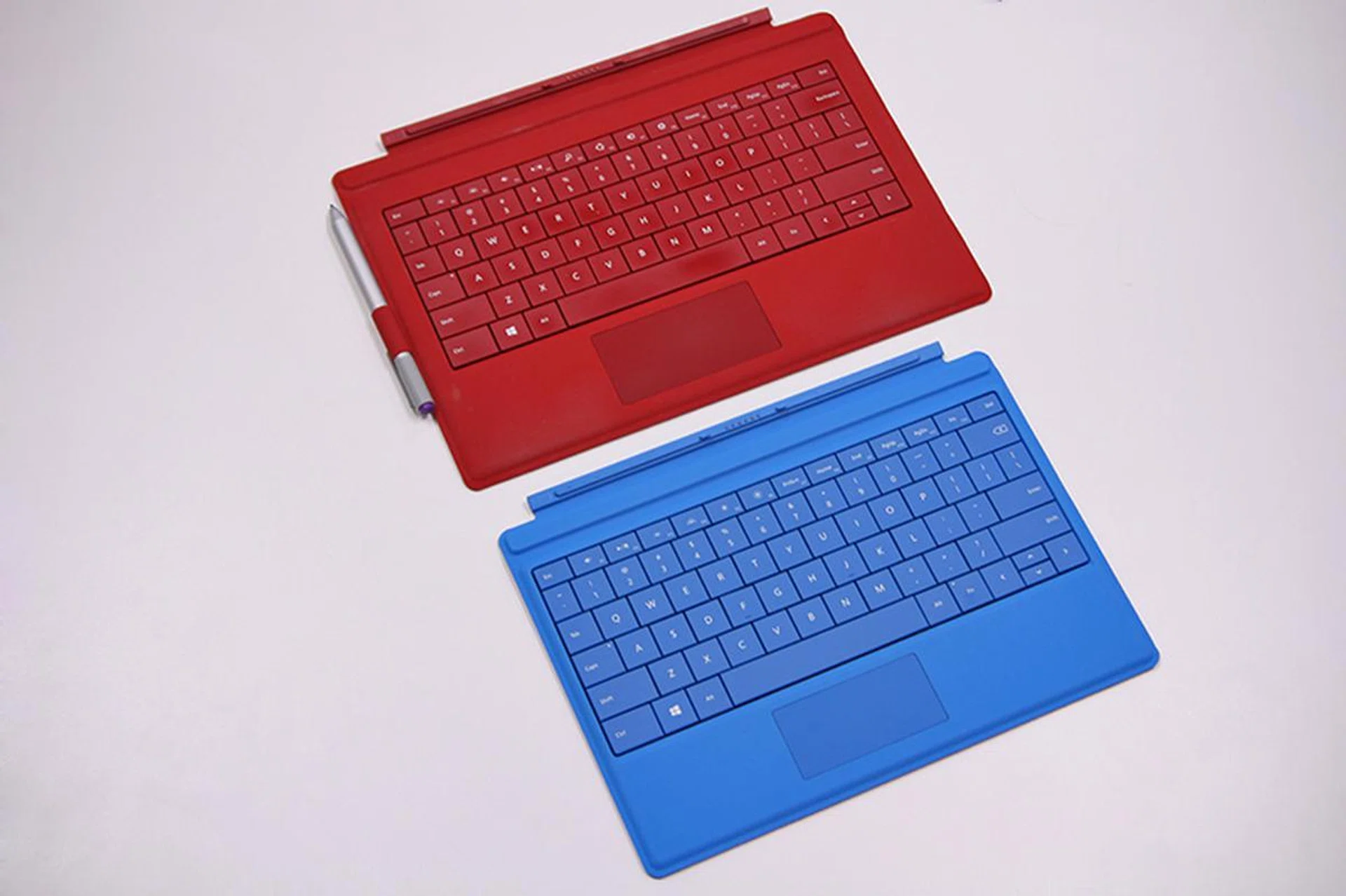 The Type Cover for Surface 3 (the one in blue), while smaller than the Type Cover for Surface Pro 3, still manages to pack a full-size keyboard with backlit keys.
