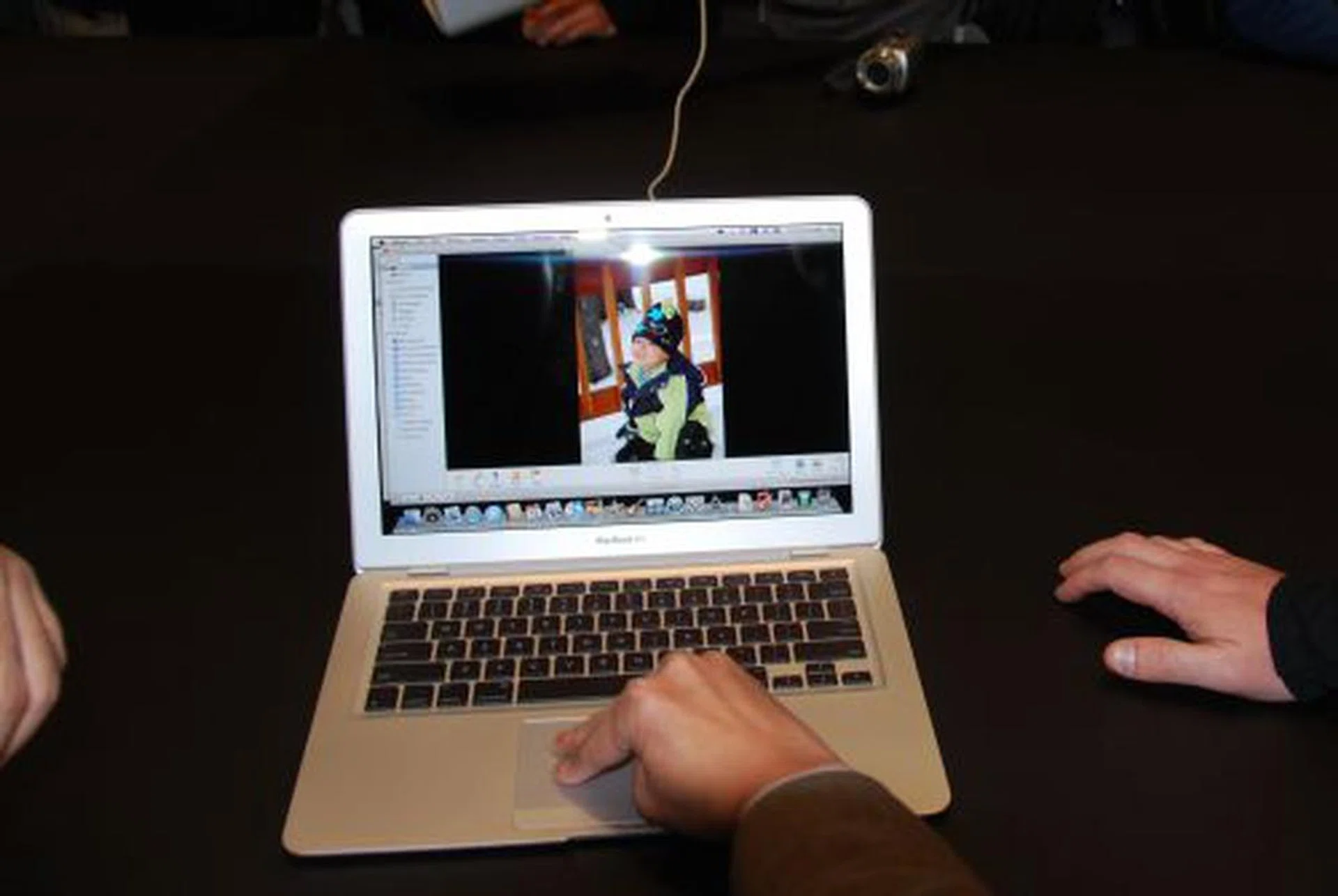 To slide across different images, you just need to slide three fingers across the trackpad either up or down.