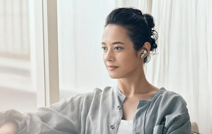 Model wearing Audio-Technica ATH-TWX7 (inside ear).