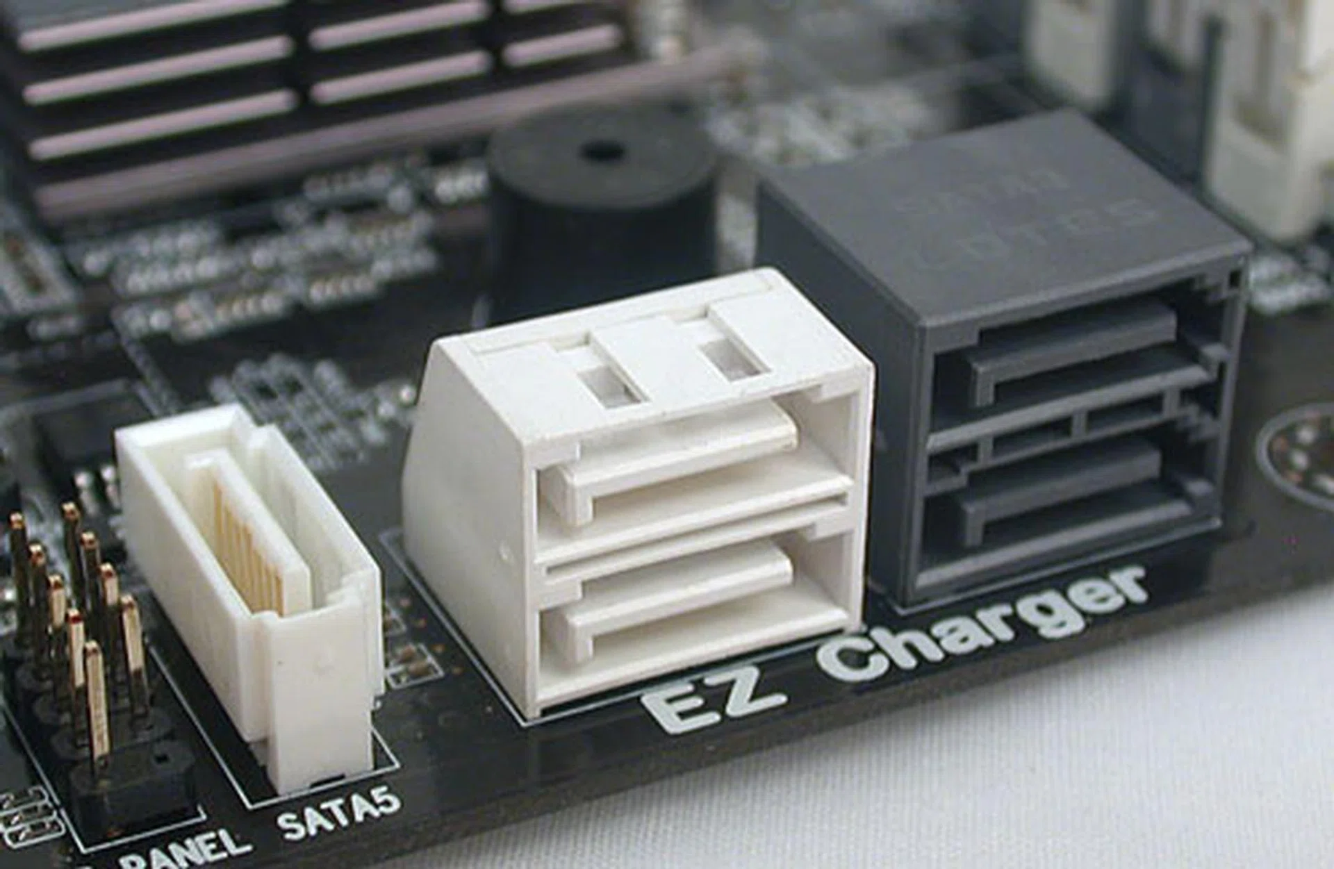 The SATA ports from the chipset are aligned facing outward to avoid interfering with your graphics card. Black for SATA 6Gbps and white for 3Gbps. The EZ charger mentioned is ECS' feature of providing more power through its USB ports to improve the speed of charging your devices. It's something we have seen from Gigabyte.