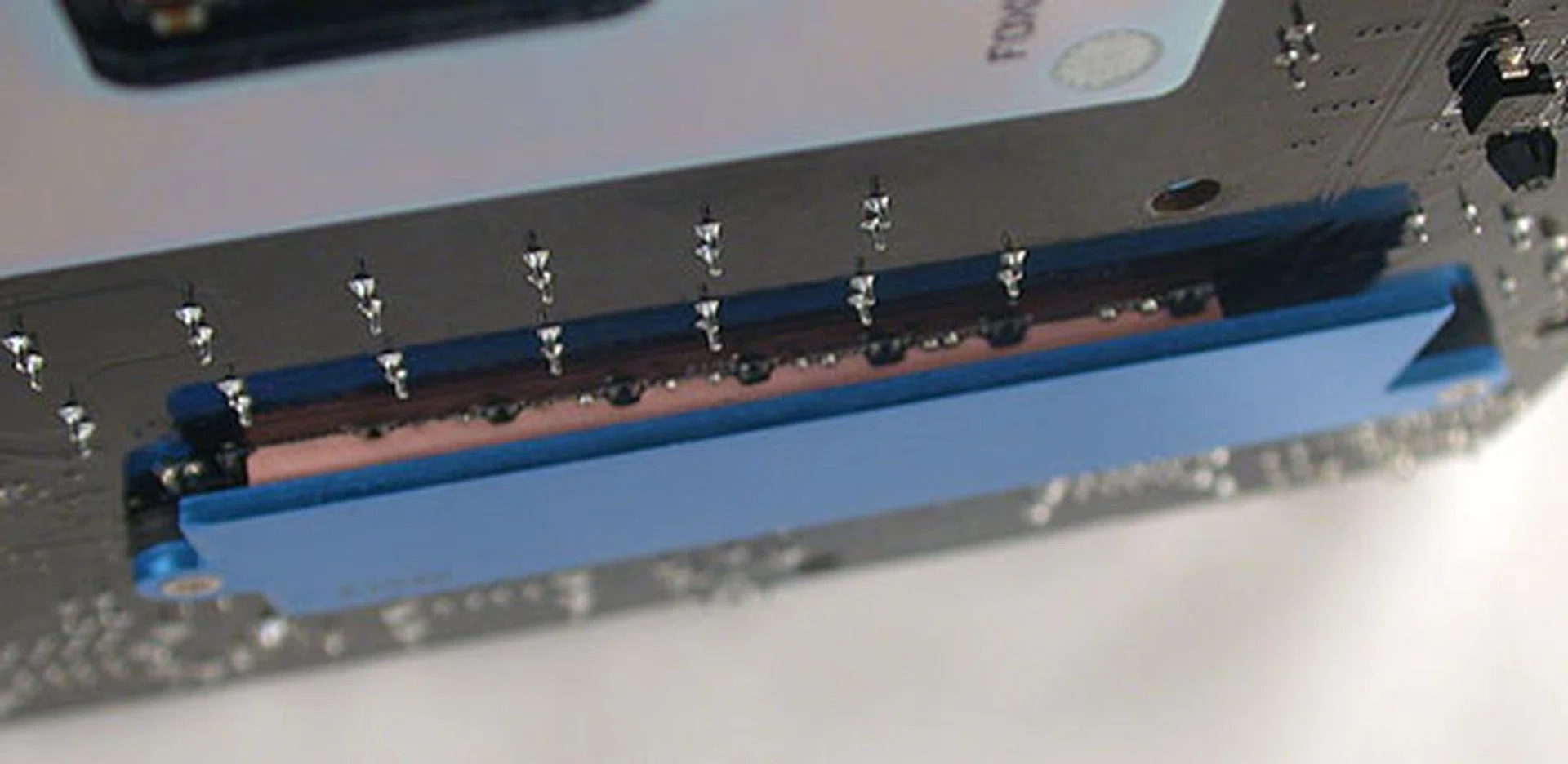 Under the board, we saw this backplate, which presumably will help with the cooling of the rear heatsink that's directly above it.