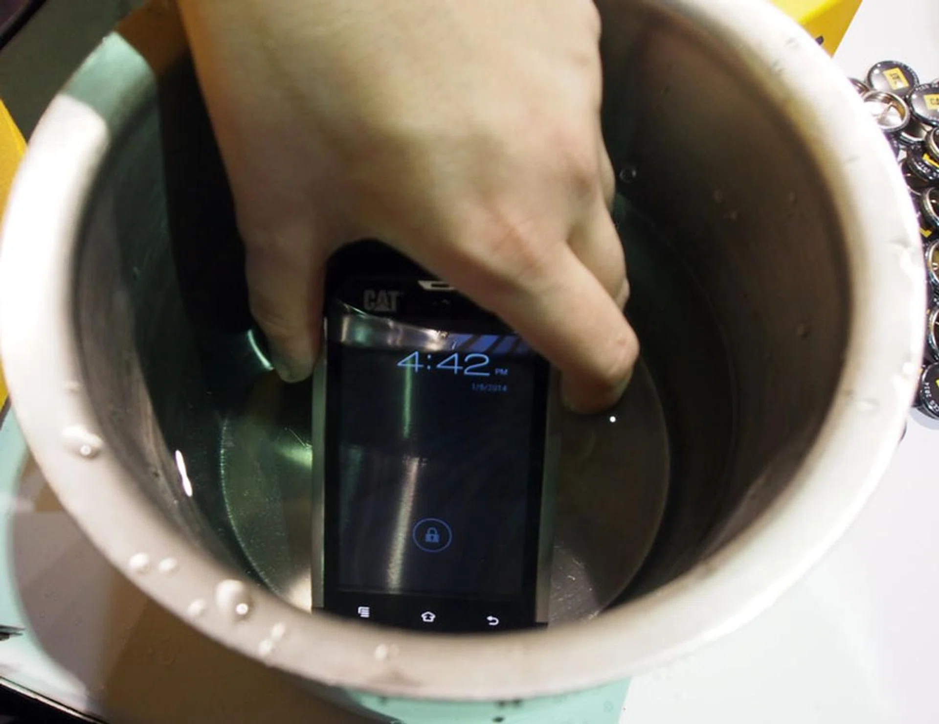CAT B15 Rugged Smartphone being submerged in water.