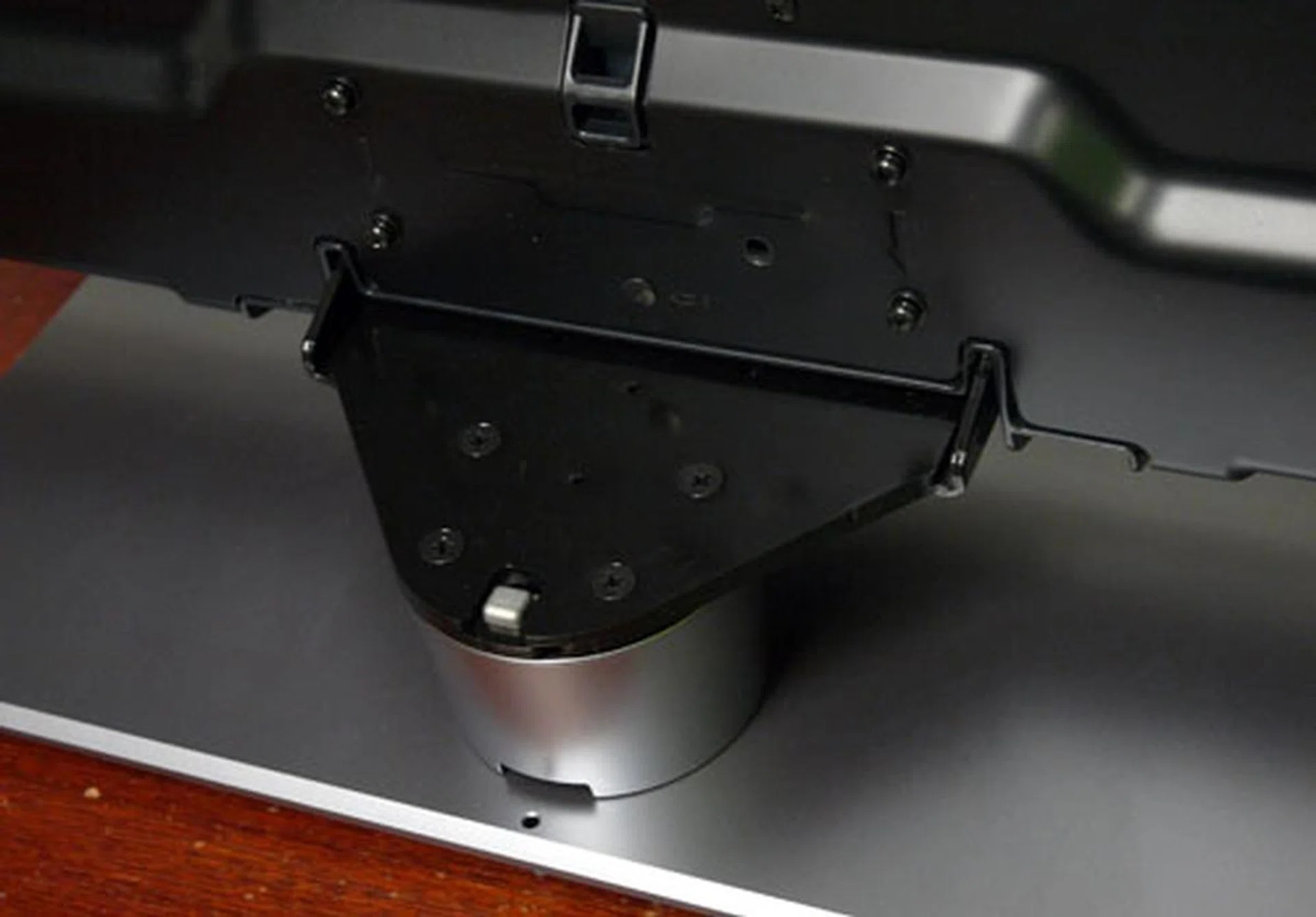 Four large screws are needed to fasten the backplate to the pedestal stand. The smaller and longer screws are used to secure the panel.