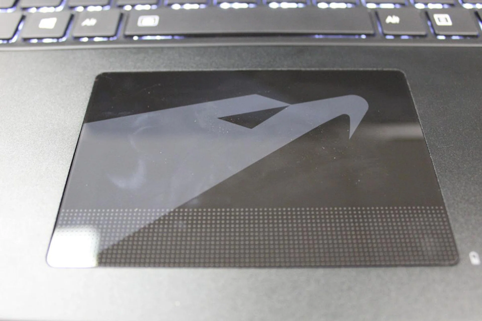 If this was the old Aorus trackpad, you can probably see our reflection in it at this angle.