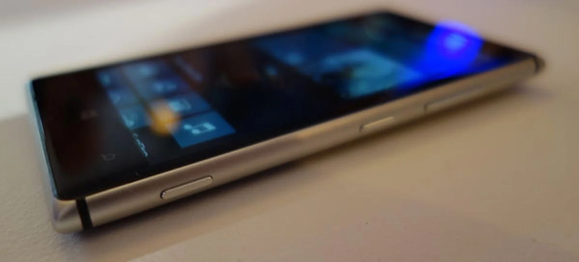 Side view, from right to left: The volume control rocker keys, power button, and the camera shutter button.