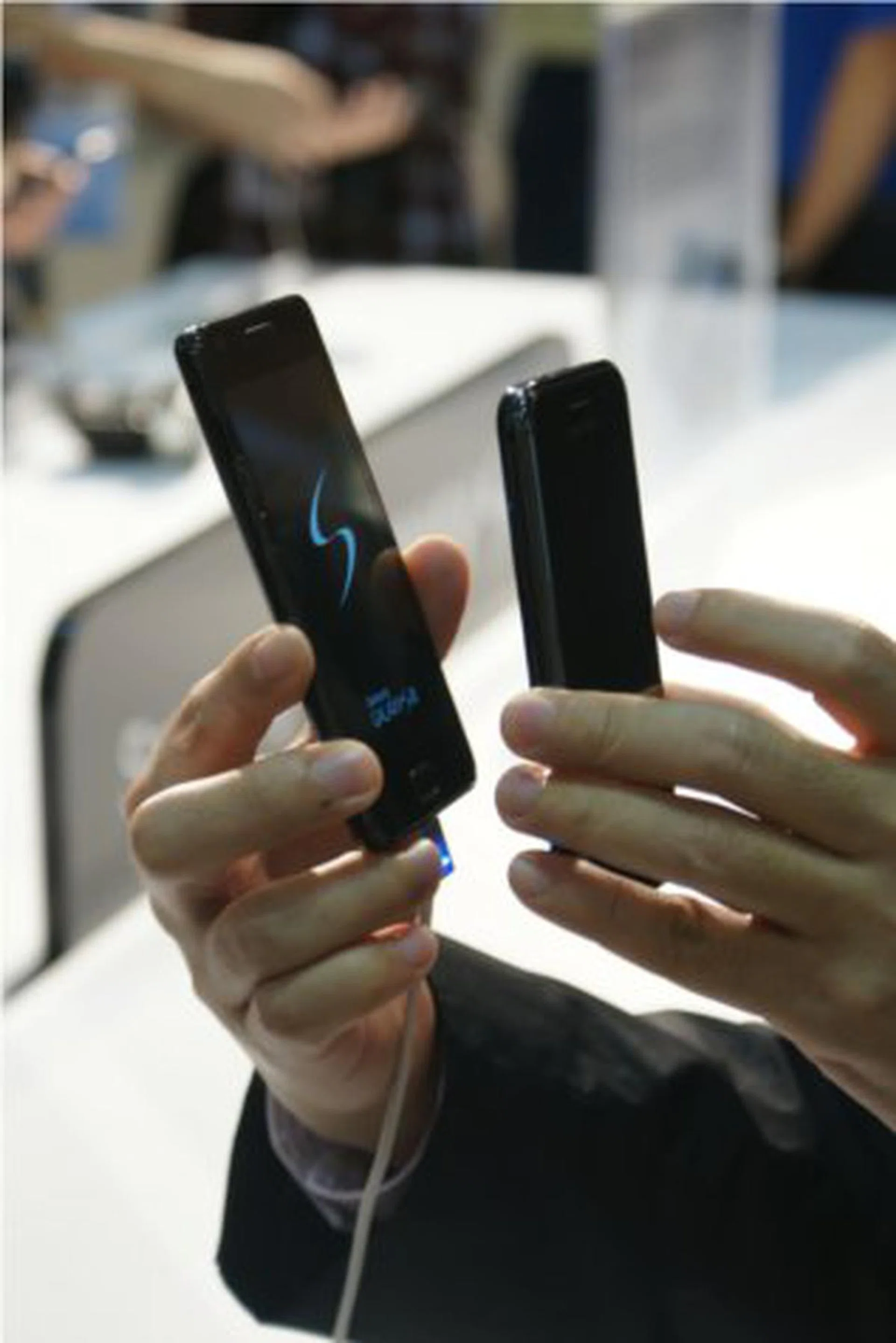 The Galaxy S II and Galaxy S held up side by side, distinctly showing the former to be thinner than its predecessor.