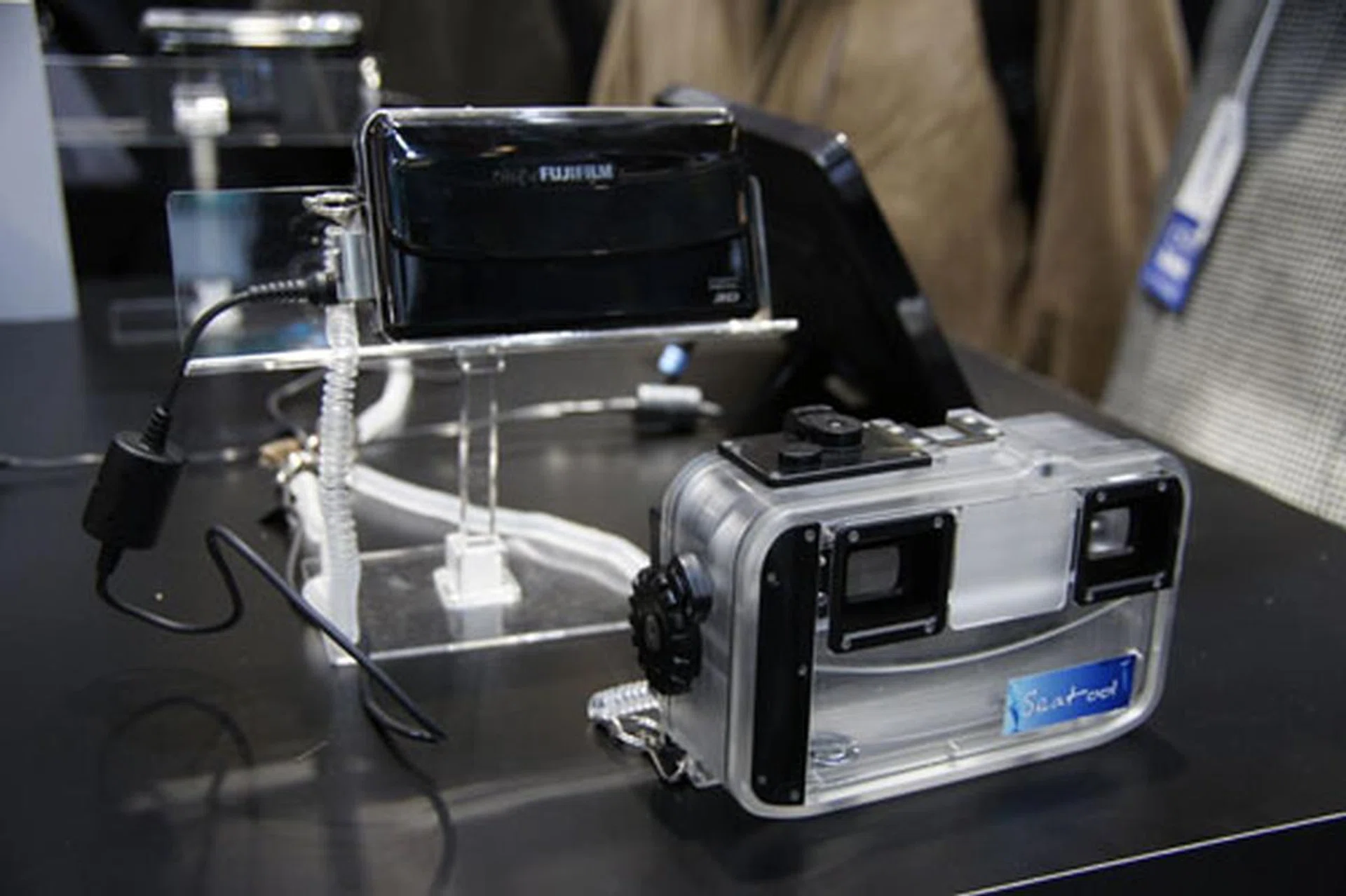 The Fujifilm FinePix REAL 3D W1 camera, released in late 2009, uses two lenses to achieve a stereoscopic 3D effect. Shown here with underwater casing.