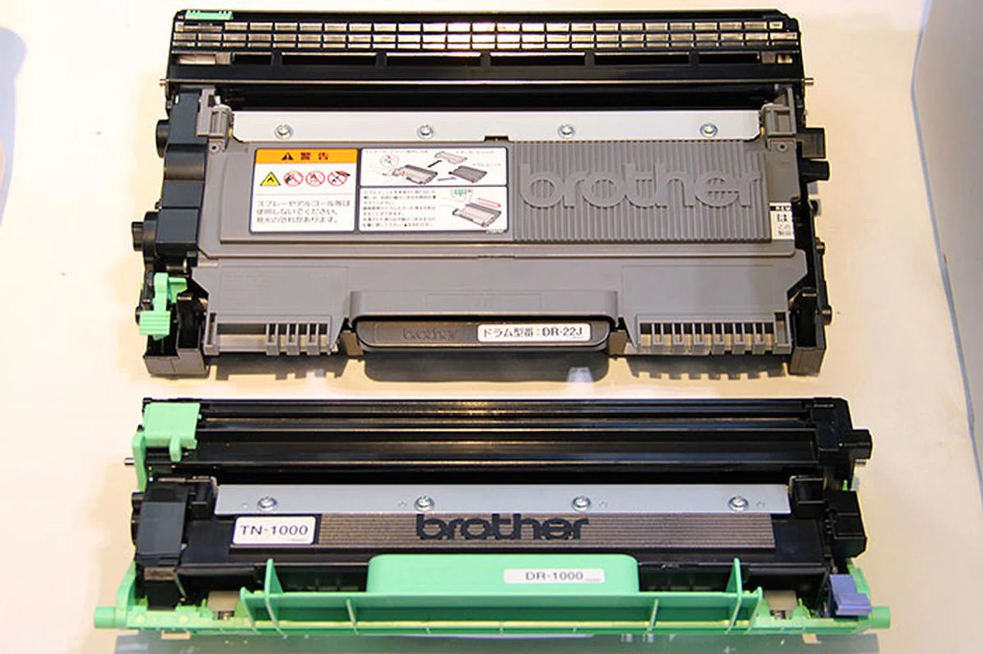 To achieve a more compact size, Brother has to reduce the size of the toner cartridge and drum. You can see that the new toner and drum (bottom: TN-1000 and DR-1000) are much smaller.