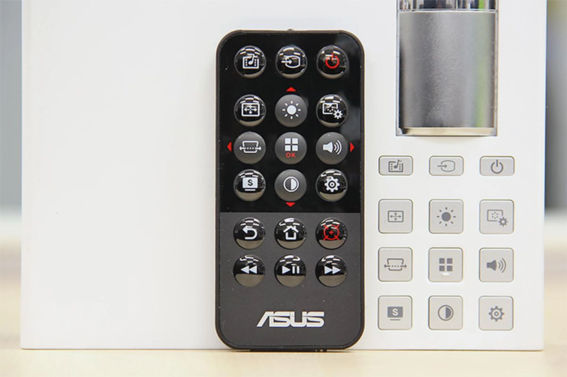 The button layout on the tiny remote control closely mimics the layout found on the P2B's top panel. 