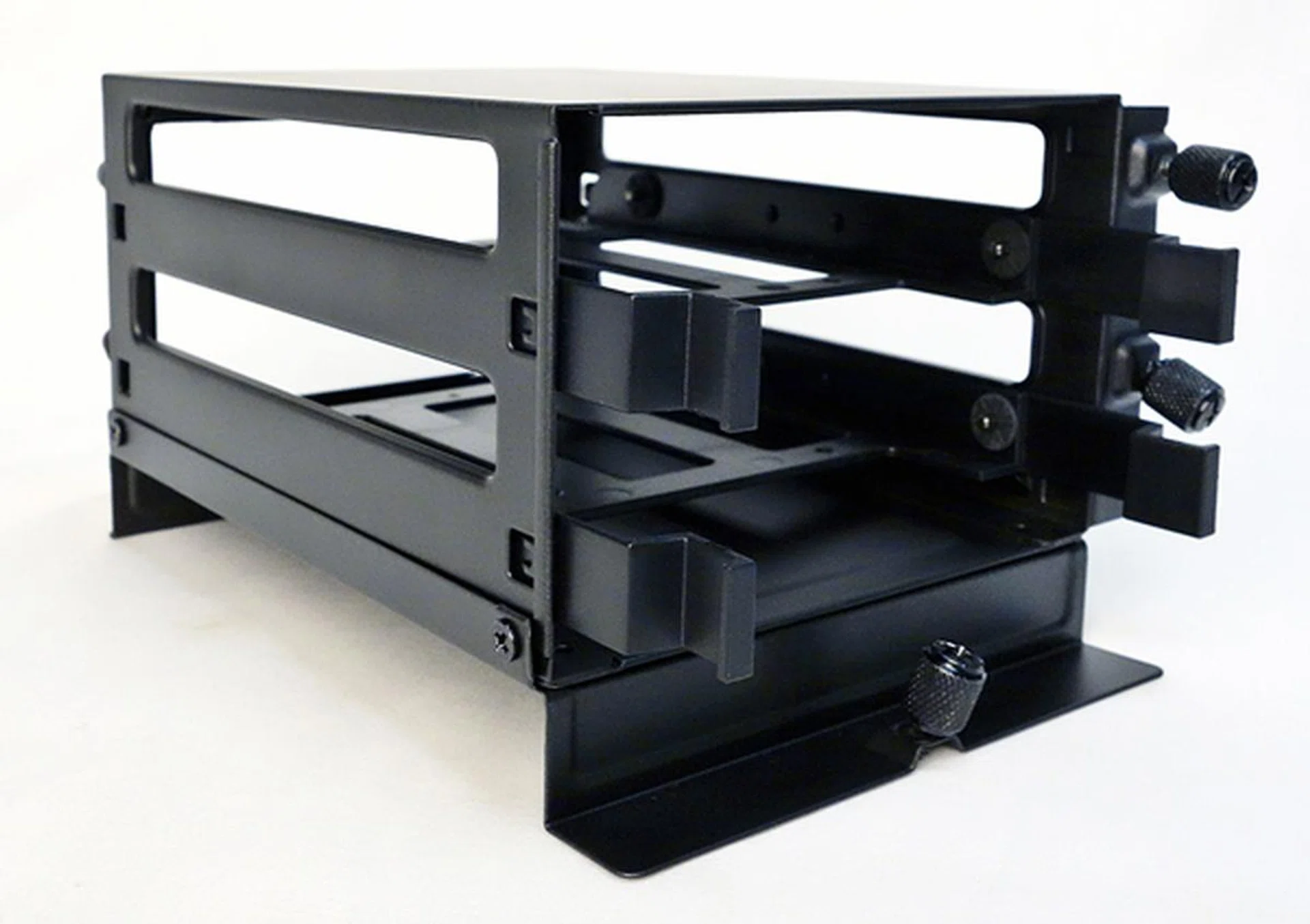 The drive cage is installed from the front of the tray, and secured with three mounting screws.
