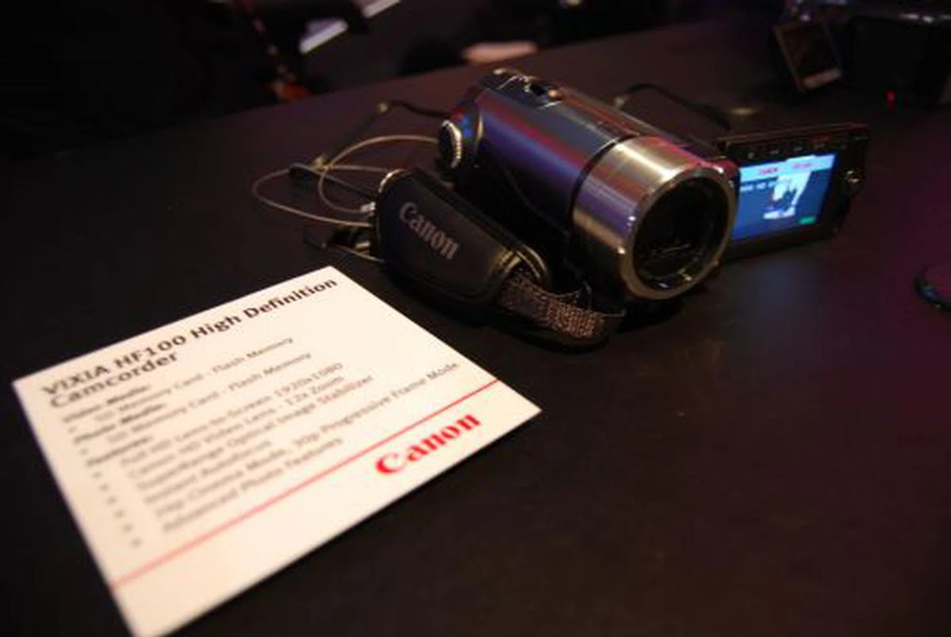   The Canon VIXIA HF10 records to either a 16GB internal flash memory or SDHC Memory card while its lesser brethren – the HF100 – records to just the SDHC Memory card. Both camcorders use the Canon 3.3 Megapixel Full HD CMOS Image Sensor (1920 x 1080) and feature a 12x optical zoom. Both the HF10 and HF100 (pictured) are expected to be available in the US from April 2008. They will be priced at US$1,099 and US$899 respectively.  