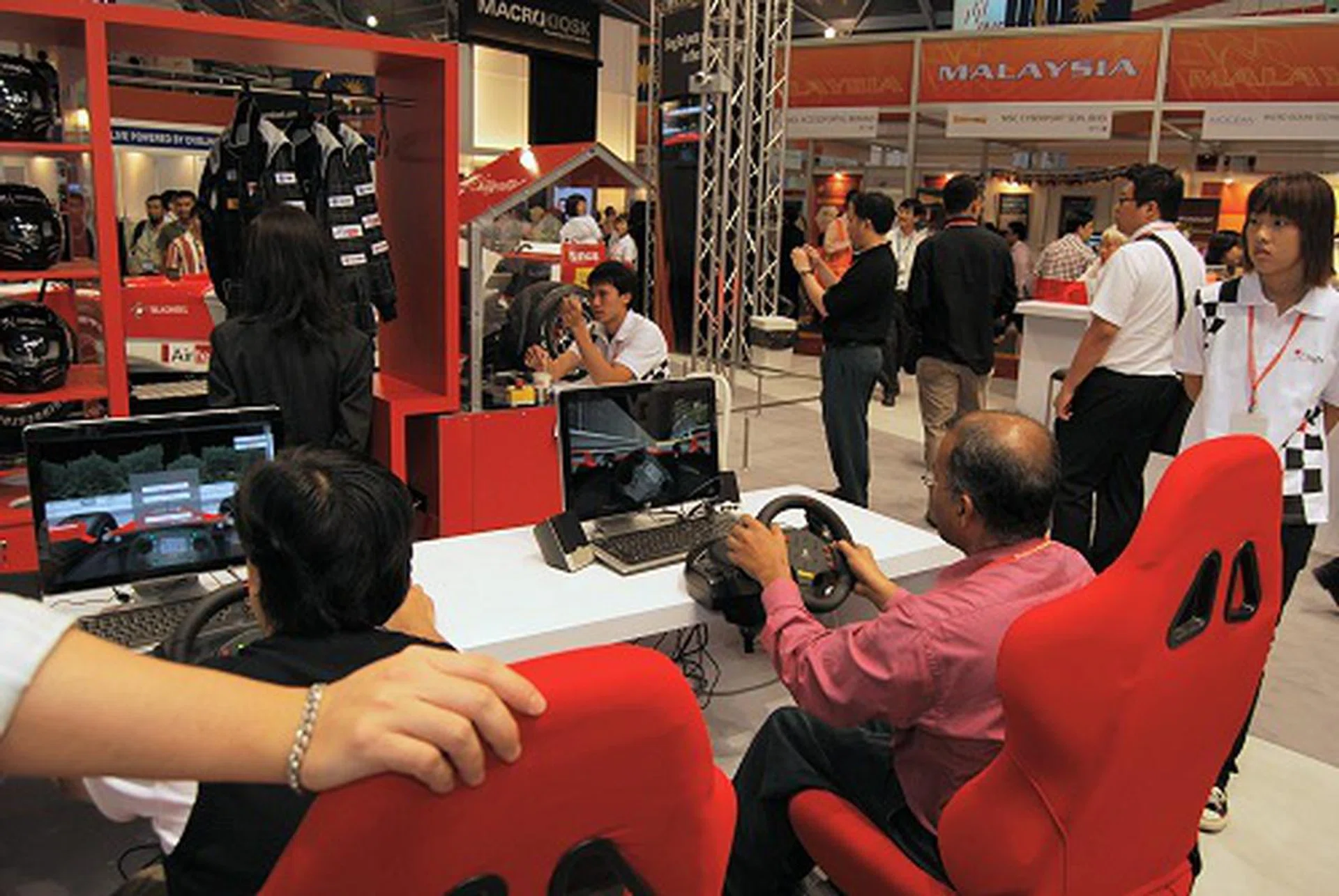  Can't wait for the F1? These people couldn't and took the opportunity to race at breakneck speeds at Singte's booth.  