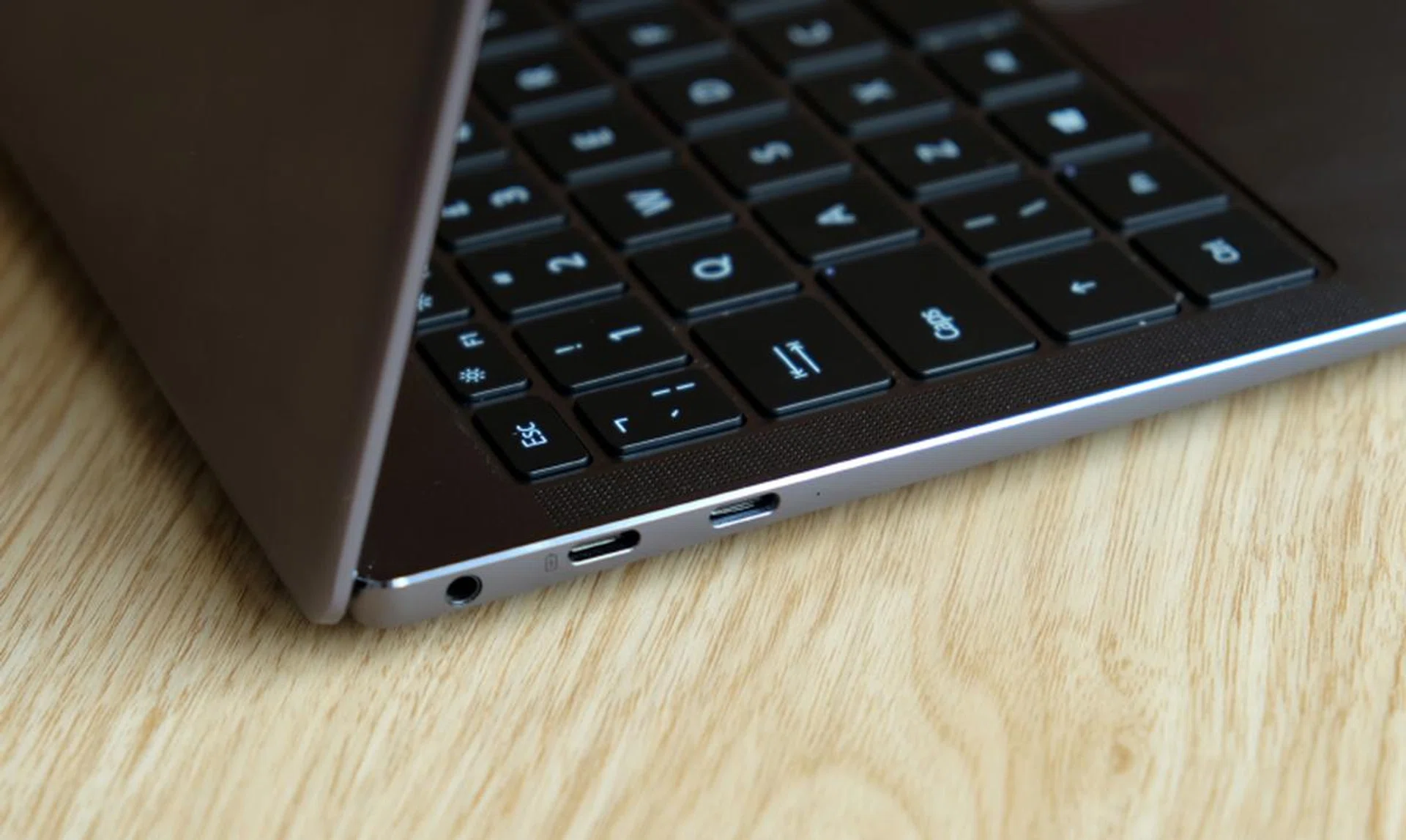 On the left side of the notebook are two USB-C ports and a 3.5mm audio jack.