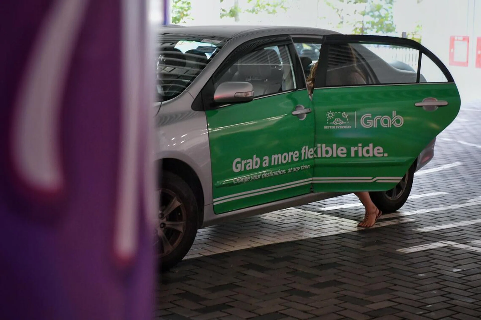 A lady entering a Grab private-hire car at Our Tampines Hub on 20 Nov 2018.