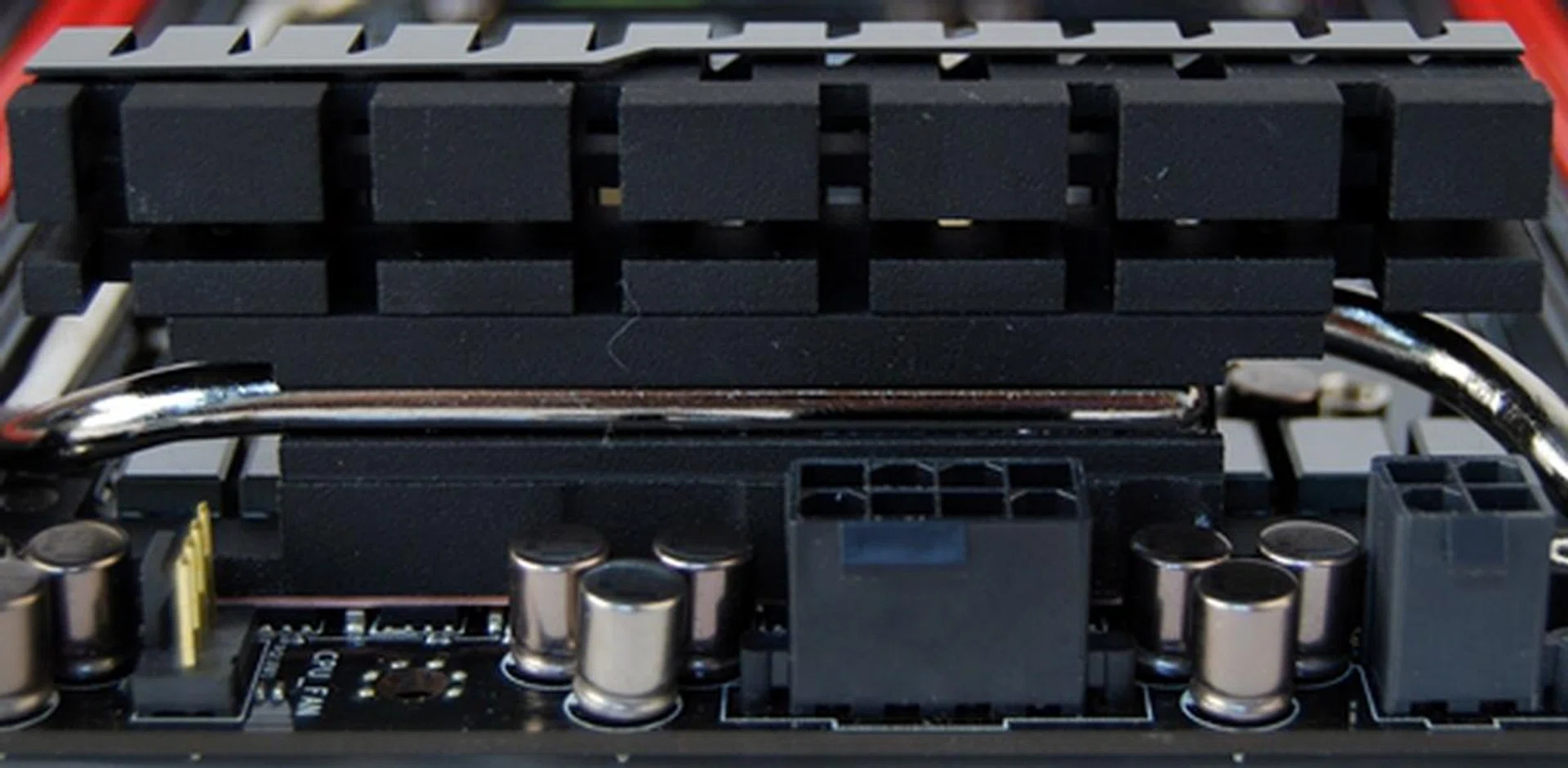 One of the VRM heatsink with the part of silver heatpipe embedded in its groove.