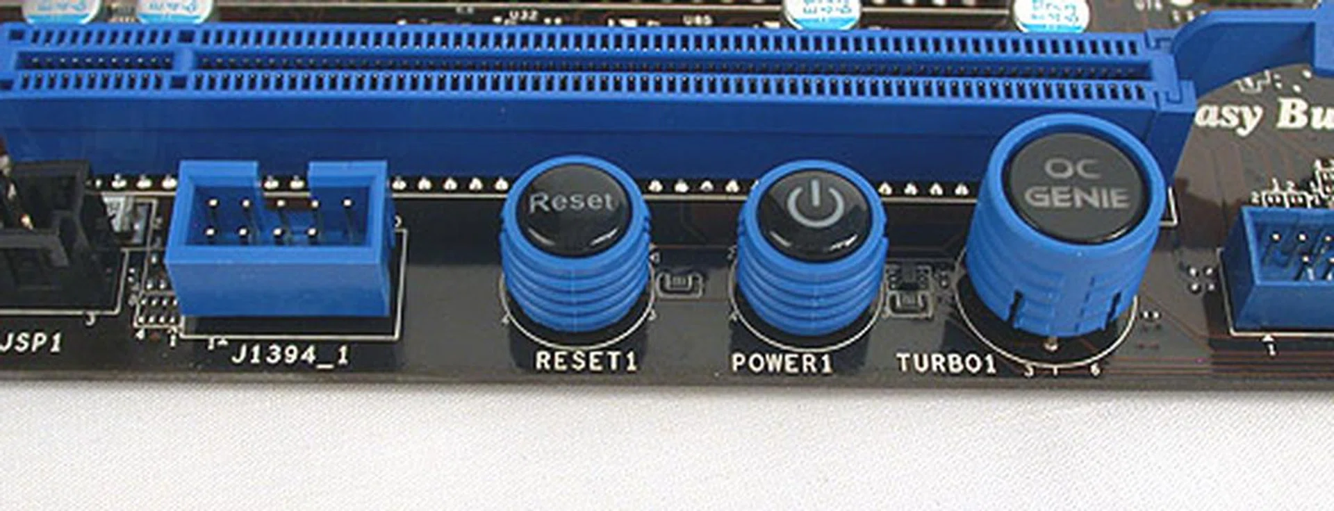The power and reset buttons are clearly labeled. The OC Genie feature works decently, giving us an overclock of up to 4.2GHz. Users have to shut down the system, depress the OC Genie button to enable it, then restart the system before it kicks in.