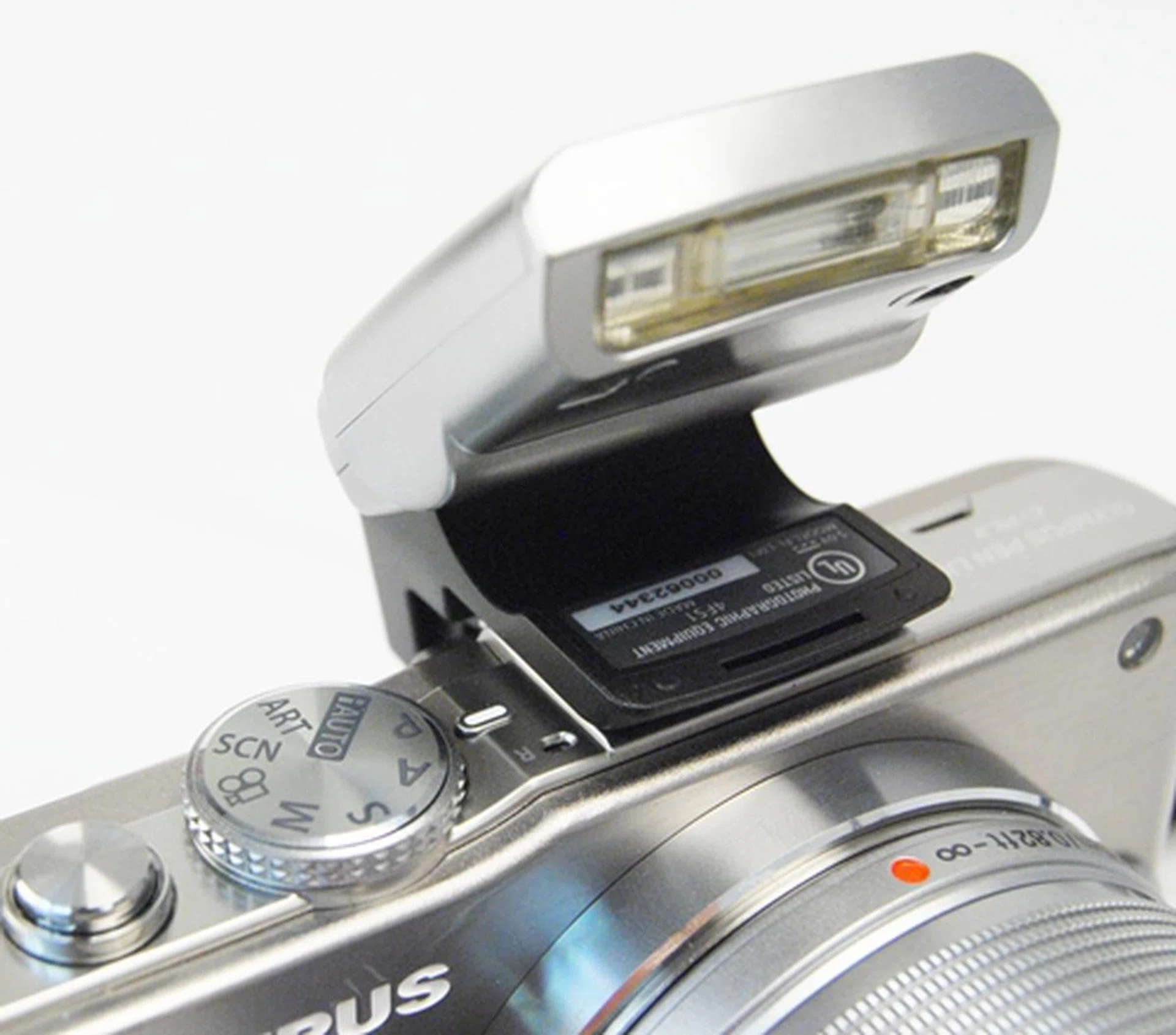 The E-PL3 is shipped with a compact flash accessory that uses both the hot shot and accessory port. It is easy to attach on and comes with a secure locking mechanism; the downside is that you cannot use the optional EVF accessory with it on.