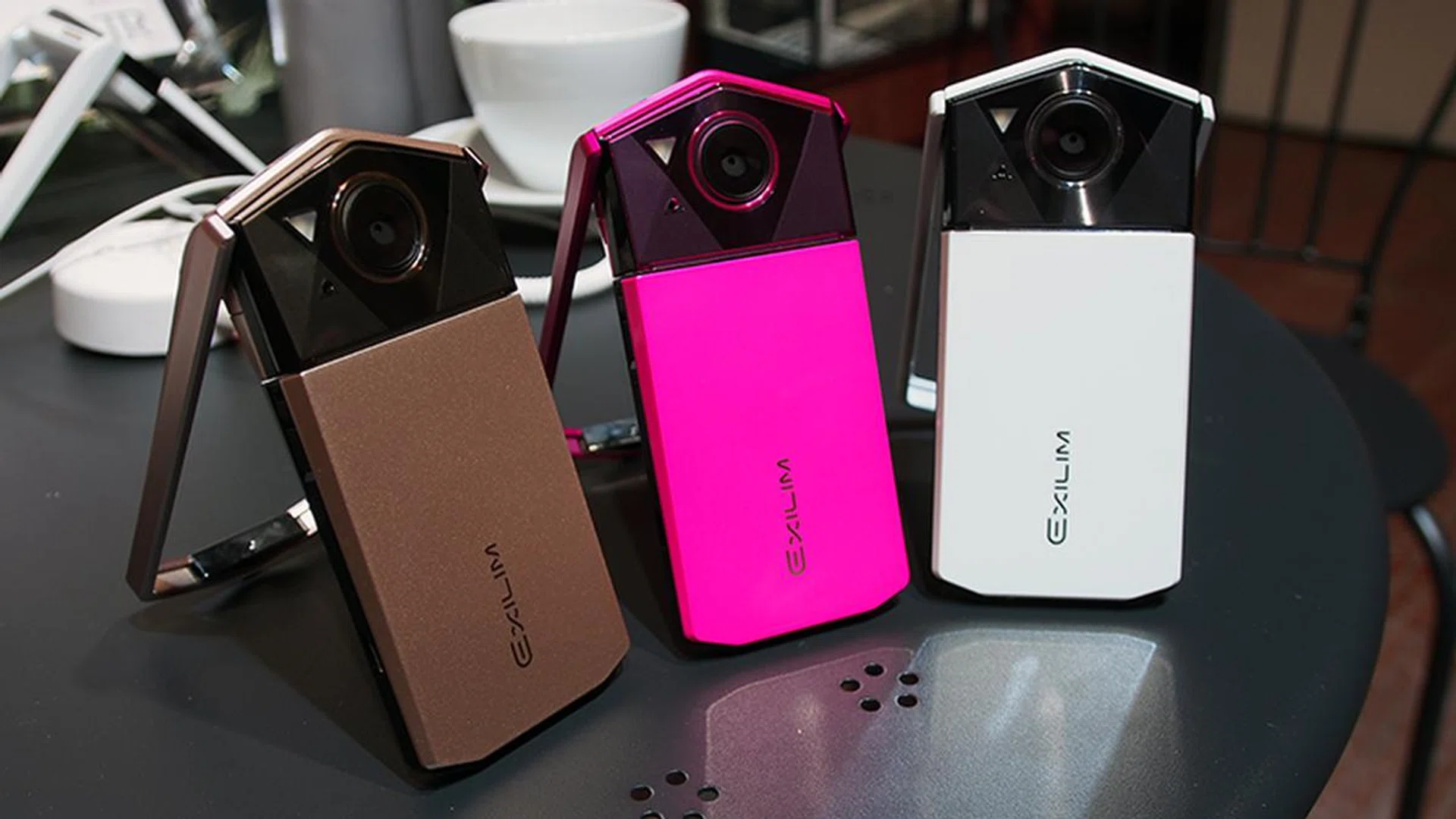 Casio EXILIM EX-TR70 in Gold, Pink, and White.