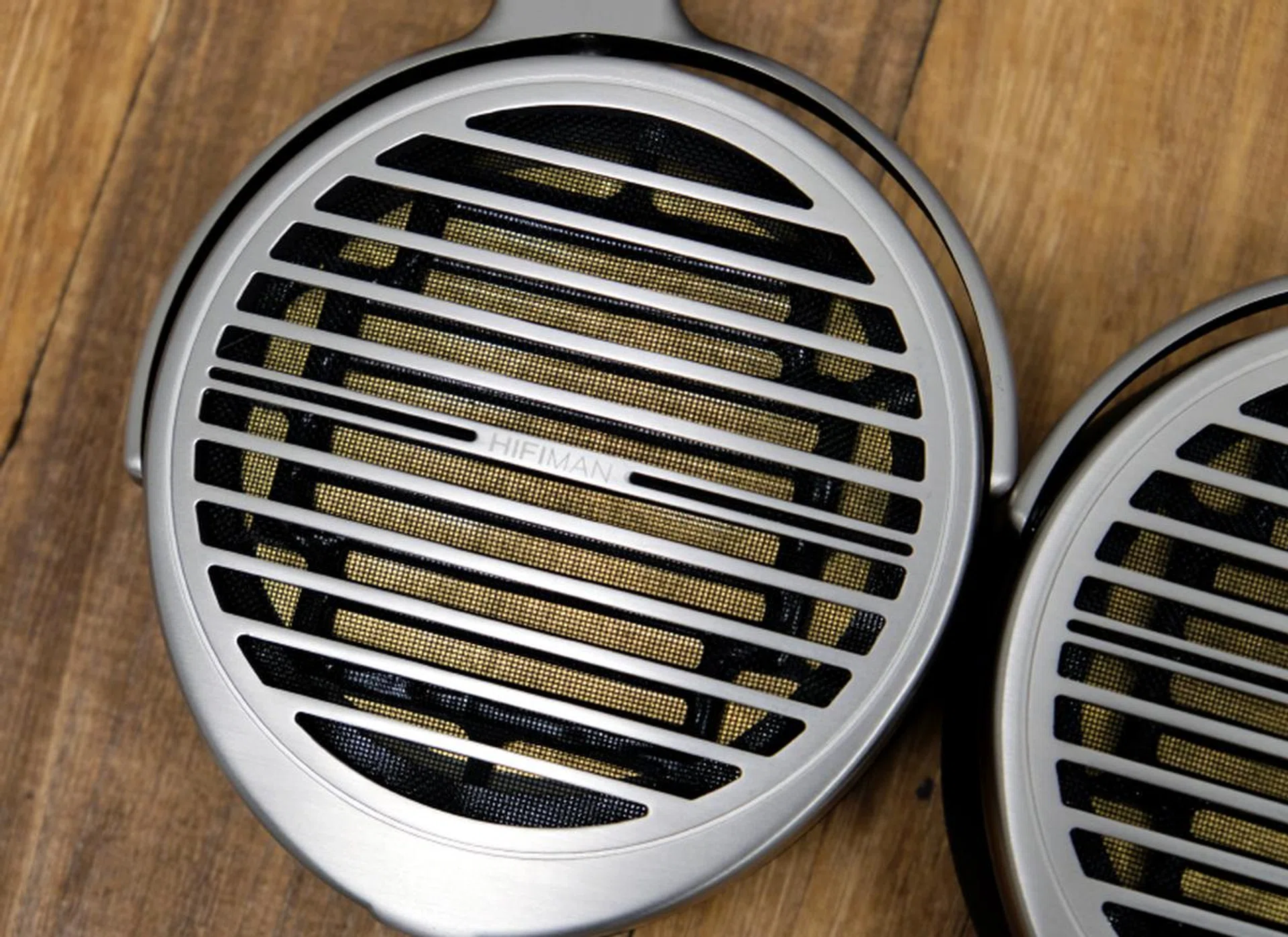 The specially designed Window Shade filters behind the driver help reduce unwanted resonant frequencies. Note also the gold voice-coil traces in the diaphragm.