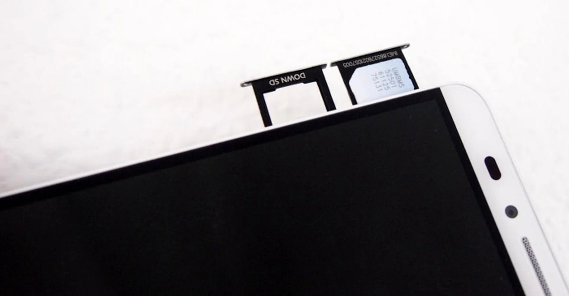 You will see the microSD and micro-SIM card slots on the left side of the device. A pin is required to eject the card trays.