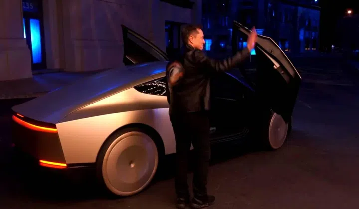Elon Musk arriving at the event in a robotaxi. Image: Tesla