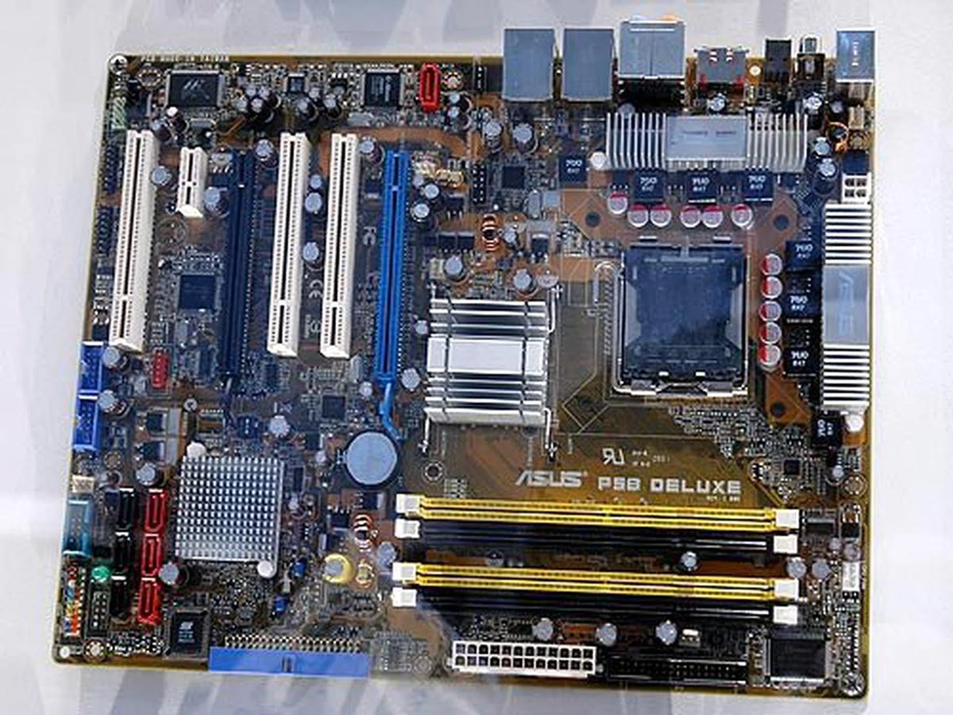 The ASUS P5B Deluxe is based on the upcoming Intel P965 chipset supporting the soon to be introduced Conroe family of processors. The board comes with SATA 3G RAID, dual Gigabit Ethernet LAN, IEEE 1394a and eight-channel high definition audio.