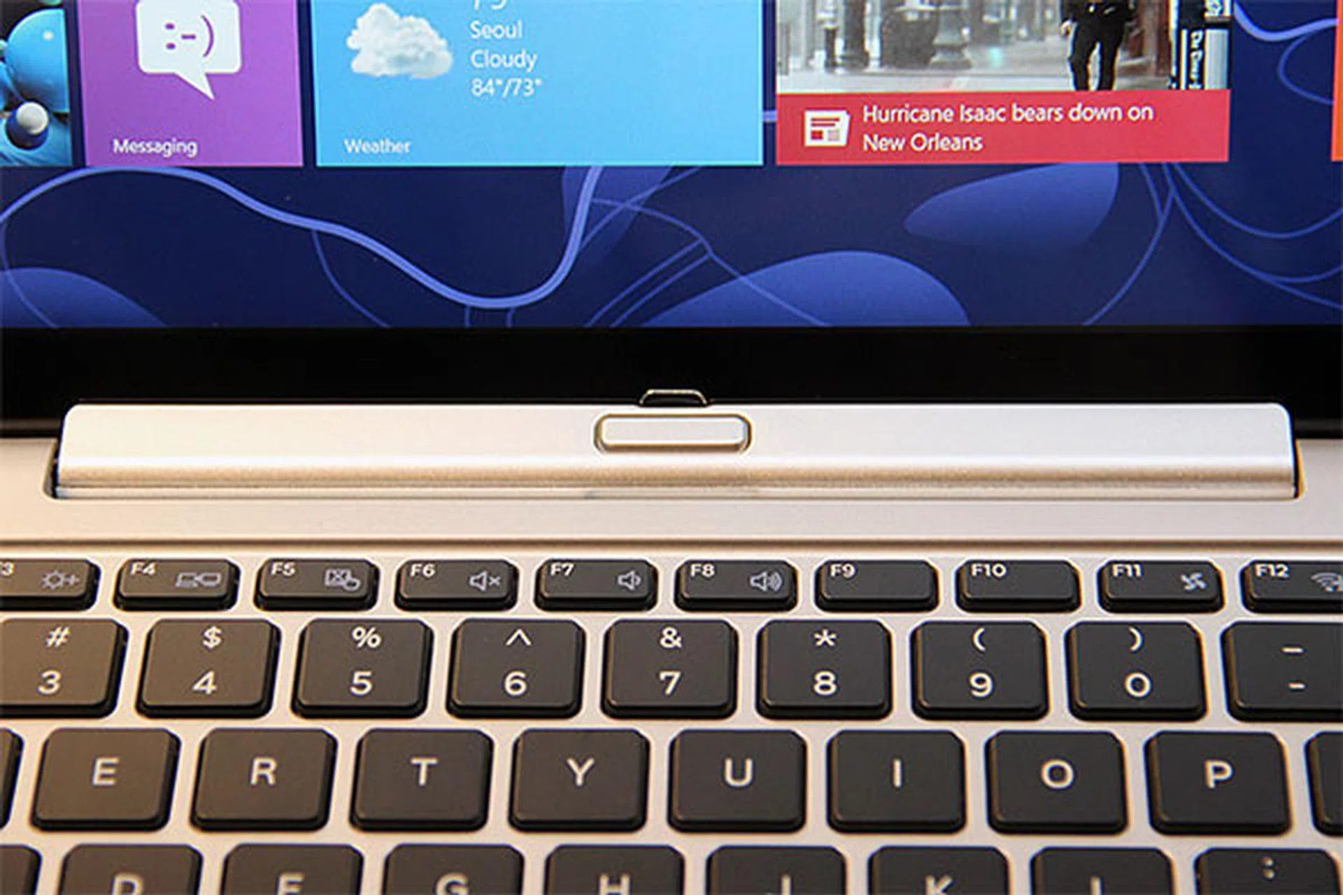 To release the tablet from the keyboard, you've to press a mechanical switch at the center. 