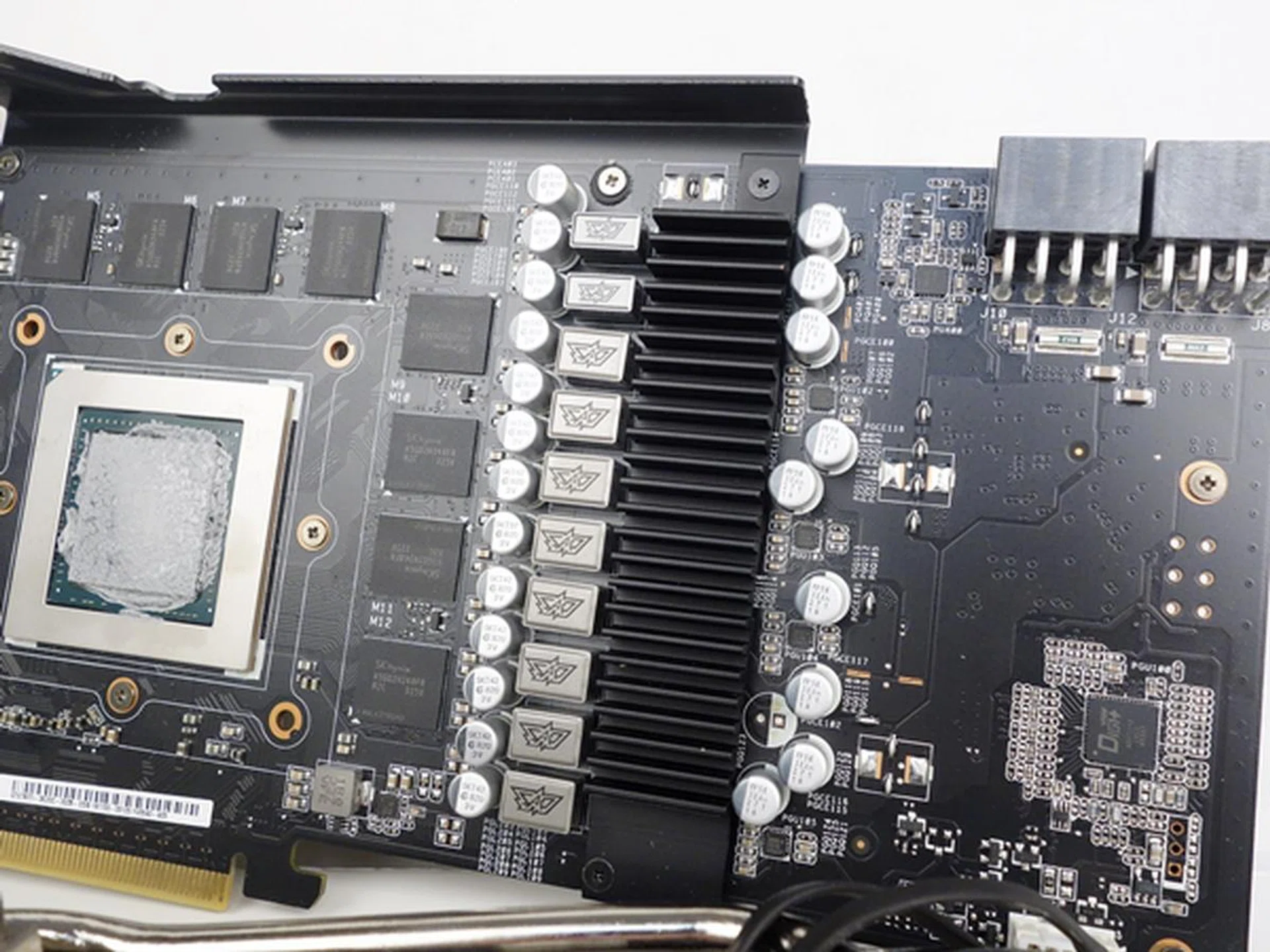 After removing the cooling fans and heatsink, we can see the VRM heatsink clearly. The card features Super Alloy Power capacitors, chokes, and MOSFETs that make up the card's Digi+ VRM digital power delivery design.